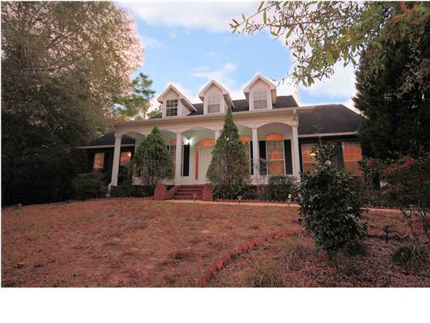 PRICE REDUCED! Magnificent all brick, colonial style home on 1 ACRE of land in a lovely, quiet neighborhood, protected with whole house generator added in 2010. With a little TLC this home could be spectacular. Upon entering the foyer and formal dining room are adorned with oak hard wood floors, crown molding, and 10' ceilings. The living room is complete with a gas fireplace that is flanked by double French doors that open to large covered porch. Spacious country style kitchen, houses custom oak cabinets with pull out storage shelves ,easy clean cook top,island w/breakfast bar,built-in pantry, and built-in desk and storage . Laundry room and half bath found off of kitchen.