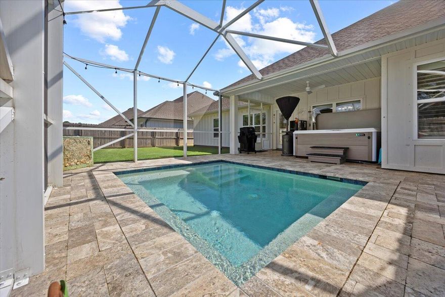 This gorgeous 4-bedroom, 3-bathroom, 3- car garage home with a fully enclosed gunite pool has been thoughtfully designed from the ground up! Situated on just under a 1/4 acre lot, this home offers a fabulous open-concept floor plan that's perfect for everyday living and effortless entertaining.Step inside and prepare to be WOWED by the elegant features throughout:*Plantation shutters*Whole-home water filtration system with built-in softener*Sprinkler system*Spacious living room with trey ceilings, perfect for relaxing on cozy eveningsThe kitchen is an entertainer's dream, featuring:*Custom staggered upgraded cabinetry*Samsung Smart refrigerator*Glass tile backsplash*Farmhouse sink*Large island with granite countertopsRetreat to your private master suite complete with:
*Expansive walk-in closet
*Custom master bath with soaking drop-in tub with tile surround
*Granite double vanity
*Separate tiled shower with frameless glass door

On the opposite side of the living room are three additional bedrooms, each with an adjacent bathroom and plenty of closet space -ideal for family or guests.

Outdoor living is just as impressive! Enjoy evenings on your 27'x19' covered lanai overlooking the luxurious travertine-tiled pool and fully fenced backyard. This home was truly made for hosting friends and family.

 Top Features You'll Love:
*Oversized walk-in pantry for fewer grocery trips
*Large walk-in closets in master and spare bedroom
*Extra-large entry and linen storage closets for easy organization
*Granite countertops throughout with a relaxed coastal vibe
*Easy-to-clean wood-look tile floors for an upscale feel
*Smart appliances included with an acceptable offer (refrigerator with self-fill water pitcher & dual ice makers, plus smart washer/dryer with large and small-load capacity)

Peaceful neighborhood setting with underground utilities just minutes from Navarre & Pensacola Beach. 
Quick access to downtown Pensacola via Hwy 98 or the Gar??on Point Bridge. 
New Soundside High School is under construction nearby & estimated to be completed in January 2026. With proximity to the Waters Edge community, new students begin enrolling in August 2026! 

Backyard oasis with a plunge-style pool 
Bonus: With an acceptable offer, the seller will also include the 1-year-young Hot Springs therapeutic hot tub to elevate your backyard oasis even further! 
Discover the perfect blend of comfort and coastal living- schedule your private showing today!