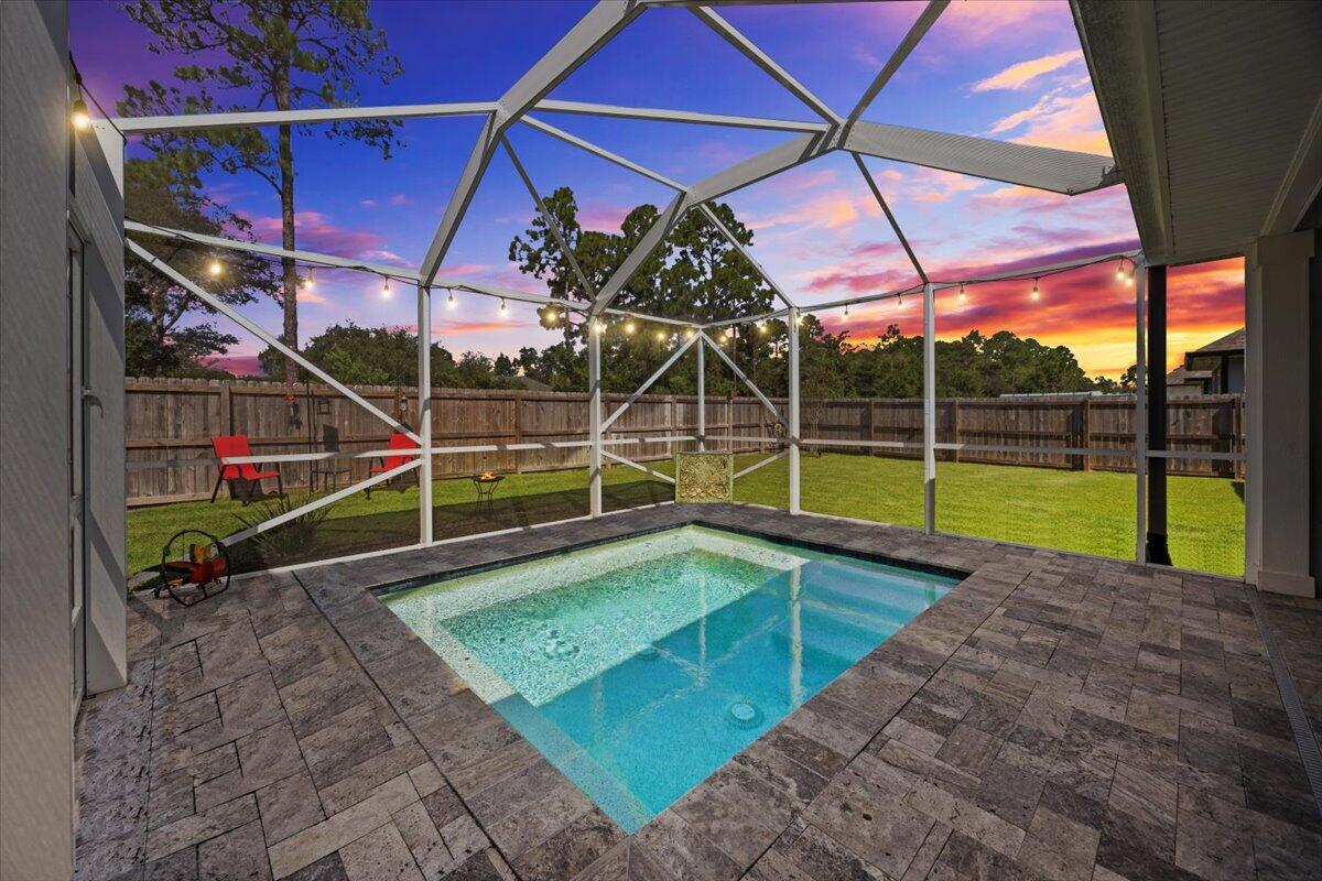 This gorgeous 4-bedroom, 3-bathroom, 3- car garage home with a fully enclosed gunite pool has been thoughtfully designed from the ground up! Situated on just under a 1/4 acre lot, this home offers a fabulous open-concept floor plan that's perfect for everyday living and effortless entertaining.Step inside and prepare to be WOWED by the elegant features throughout:*Plantation shutters*Whole-home water filtration system with built-in softener*Sprinkler system*Spacious living room with trey ceilings, perfect for relaxing on cozy eveningsThe kitchen is an entertainer's dream, featuring:*Custom staggered upgraded cabinetry*Samsung Smart refrigerator*Glass tile backsplash*Farmhouse sink*Large island with granite countertopsRetreat to your private master suite complete with:
*Expansive walk-in closet
*Custom master bath with soaking drop-in tub with tile surround
*Granite double vanity
*Separate tiled shower with frameless glass door
On the opposite side of the living room are three additional bedrooms, each with an adjacent bathroom and plenty of closet space -ideal for family or guests.
Outdoor living is just as impressive! Enjoy evenings on your 27'x19' covered lanai overlooking the luxurious travertine-tiled pool and fully fenced backyard. This home was truly made for hosting friends and family.
Top Features You'll Love:
*Oversized walk-in pantry for fewer grocery trips
*Large walk-in closets in master and spare bedroom
*Extra-large entry and linen storage closets for easy organization
*Granite countertops throughout with a relaxed coastal vibe
*Easy-to-clean wood-look tile floors for an upscale feel
*Smart appliances included with an acceptable offer (refrigerator with self-fill water pitcher & dual ice makers, plus smart washer/dryer with large and small-load capacity)
Peaceful neighborhood setting with underground utilities just minutes from Navarre & Pensacola Beach.
Quick access to downtown Pensacola via Hwy 98 or the Gar??on Point Bridge.
New Soundside High School is under construction nearby & estimated to be completed in January 2026. With proximity to the Waters Edge community, new students begin enrolling in August 2026!
Backyard oasis with a plunge-style pool
Bonus: With an acceptable offer, the seller will also include the 1-year-young Hot Springs therapeutic hot tub to elevate your backyard oasis even further!
Discover the perfect blend of comfort and coastal living- schedule your private showing today!
