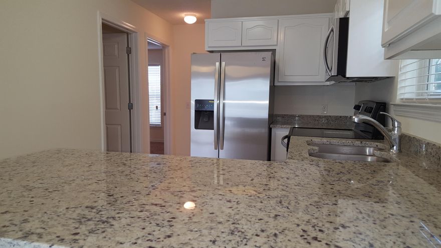 DEVELOPER UNIT !!Like new, completely renovated including granite kitchen counter tops w/under-mount stainless steel sink, all new stainless steel appliances, new faux wood window blinds, new sliding glass door blind, new paint thru-out. Beach access is directly south of community. Nice community pool with showers and restrooms. Association provides basic cable,trash and grilling area....GREAT NEWS; We are now VA approved !!