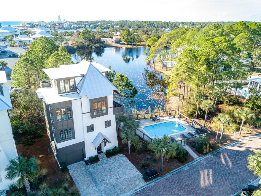 Located south of 30A in the quaint 9 home neighborhood of Tresca Place, 40 Seapointe Ln was built on a prime lot overlooking the adjacent coastal dune lake and community pool! Recently updated the home features upgrades throughout such as built-in first floor bunk room, elevator, custom cabinetry and tile, stainless appliances, and granite countertops.The ground floor holds a spacious enclosed garage great for parking and storage, the built-in bunk room, and a half bath. The second floor houses the two guest bedrooms, and guest bath. The open concept main living area is found on the 3rd floor. Notable features of this area include the oversized windows providing beautiful natural light, and the large island and gorgeous built-in window seating that allow for maximum use of the space