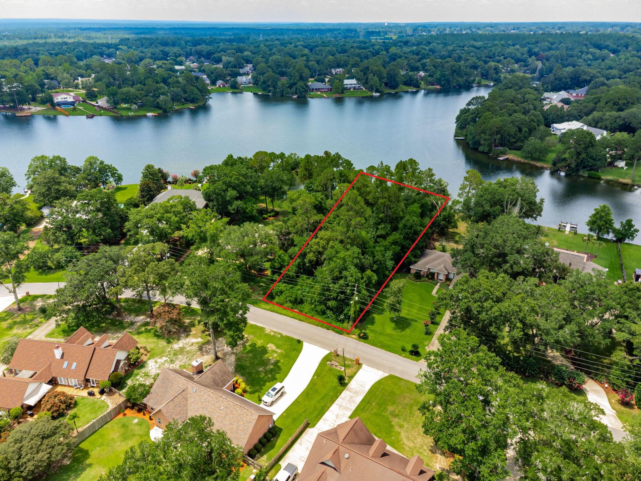 Don't miss this rare opportunity to own the last waterfront lot in the highly sought-after community of Woodbine Springs Plantation! Nestled on a generous 0.545-acre parcel, this exceptional property boasts approximately 128 feet of pristine lake frontage on a tranquil 55-acre private lake, ideal for fishing, kayaking, and paddle boating--no motorized boats allowed, preserving the peace and natural beauty of the area. The lot's unique topography includes a natural peninsula that extends from the rear of the property, creating a serene, lagoon-like setting perfect for relaxing, entertaining, or simply enjoying nature's beauty in total privacy. This heavily wooded lot offers a sense of seclusion and a blank canvas for those looking to build their dream home surrounded by mature trees and w aterfront views. Woodbine Springs Plantation is a family-friendly neighborhood known for its welcoming atmosphere and attractive amenities, including two playgrounds and a community picnic area with gazebo. Whether you're planning to build now or invest for the future, this lot represents a truly rare chance to secure your own piece of lakefront paradise in one of the area's most desirable neighborhoods!