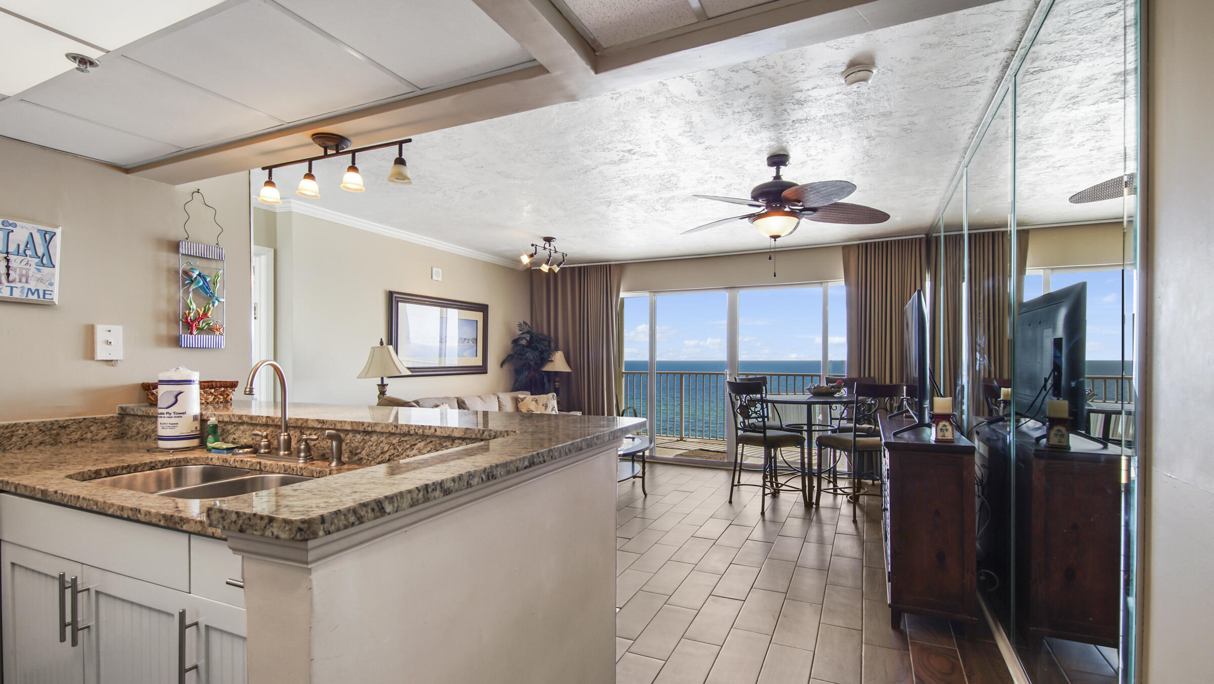 Welcome to Long Beach Resort - where stunning Gulf-front views and modern comfort meet. This beautifully updated beachfront condo offers the perfect blend of relaxation and investment potential. Whether you're looking for a personal escape or a high-performing rental, this unit has it all. Step inside to find an open, inviting space that is tastefully furnished and includes granite countertops, stylish wood-look tile throughout, and contemporary light fixtures--everything has been thoughtfully updated so you can simply enjoy. The oversized balcony, accessible from both the living room and bedroom, showcases breathtaking, unobstructed views of the turquoise water and sugar-white sands. This well-maintained condo boasts strong rental income with a solid base of repeat guests. Long Beach has everything today's beach buyer is looking for.