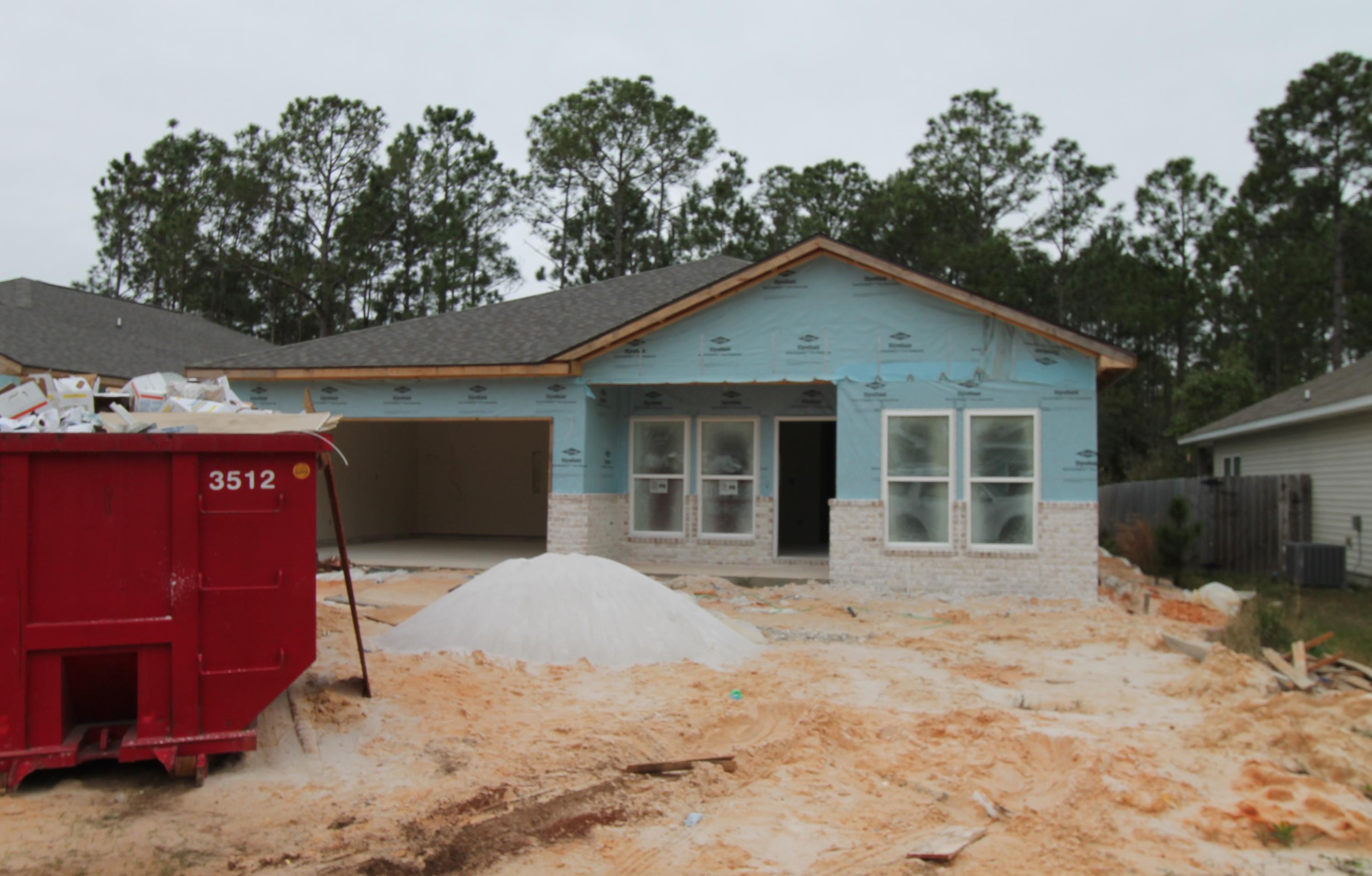 Home is much further along than pictures show. New custom 4/3, ''Craftsman Style'' floor plan, with super curb appeal. Great location!! Seller paying $3000.00 in buyer closing costs, with use of approved lender! Tom Street is on the North side of Hwy 98, just 1 minute past the Santa Rosa County line. 10 Ft. ceilings throughout main living areas, as well as tile flooring throughout main/ wet areas. As you enter the home, the dining room is at the left front, of the home. At the rear of the dining room is the kitchen, which boasts custom off - white cabinetry, a breakfast bar, granite countertops, a pantry, and stainless appliances including a refrigerator/ freezer, with ice maker. Master suite has 2 walk in closets, a double vanity, and whirlpool garden tub with separate shower.