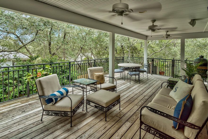 Desirable location in charming, well-established neighborhood on the west end of scenic 30A. Two beach accesses nearby with an even closer access coming soon. There is a covered area to park a golf cart for even quicker runs to the beach. Set back from the road and nestled behind tall hedges, with a wooden privacy fence for the back yard, this home offers a tranquil family retreat. The expansive deck overlooking the backyard provides ample space for outdoor living. Home was renovated in 2006. Custom features include beautiful wood flooring in bedrooms and main living area, tile flooring in baths and travertine tile laid on diagonal on first floor, plantation shutters throughout, Mauser custom cabinets and granite countertops in the kitchen. Home recently painted inside and out.