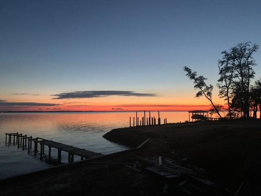 VIEWS?? ENOUGH SAID! Watch the beautiful sunset every evening from the home you desire for this lot...If you've not ventured down Red Barn Road, then I dare you to do it!  Wow, what an amazing hidden gem this road is, with the cutest directional sign nailed to the tree, takes you back in time and every home is well thought out on each lot...sometimes there is rubbish with waterfront lots, but not this street, it will surprise and stun you with a quiet drive down this shaded road.  Quick to impress.  Views of the 331 bridge and the North side of Santa Rosa Beach... Why the Freeport side?  Well they say the evening breezes are better on the Bay from the Freeport side vs. the Santa Rosa Beach side.  Lot is cleared and ready to build...Motivated Seller!

City Water and electric, City Sewer is available. . Robola Bluffs has recorded Restrictive Covenants but there is no HOA in effect at the present time - No HOA fees 