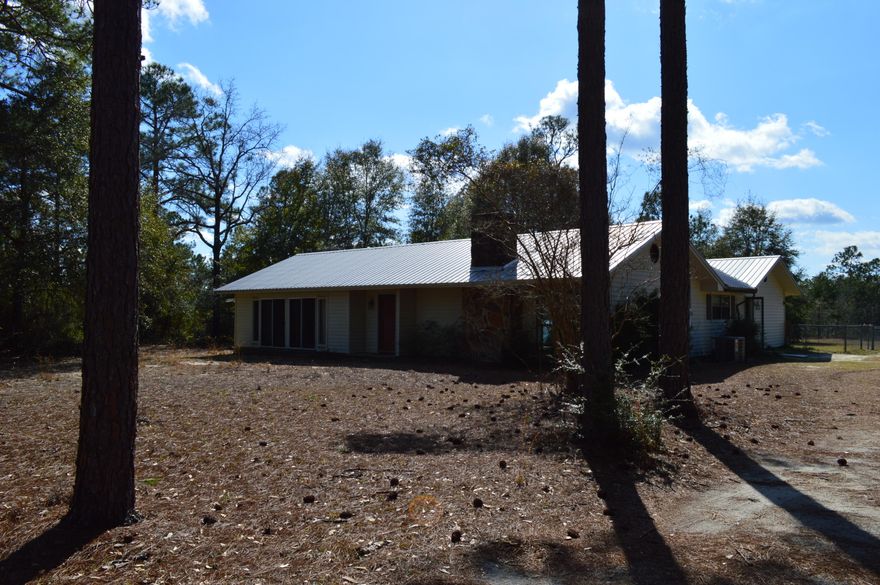 A rare find in this market....2,500+ square foot home sitting near the center of a 14 acre parcel close to the heart of Defuniak Springs but with county general agriculture zoning for cheaper taxes!!   A private and peaceful setting south of the interstate and surrounded by larger parcels giving you the country feel so close to the amenities of Defuniak Springs proper and only 30 minutes to the white sand beaches of South Walton.  Home is 2 bedrooms and 2 baths with a detached garage situated on a picturesque partially cleared and wooded 14 acres with room to spread out.  Living room and master bedroom open to a unique courtyard that would be perfect for a private garden or peaceful koi pond.  Make an appt today before this rare find is gone. Only cash and conventional loans considered.