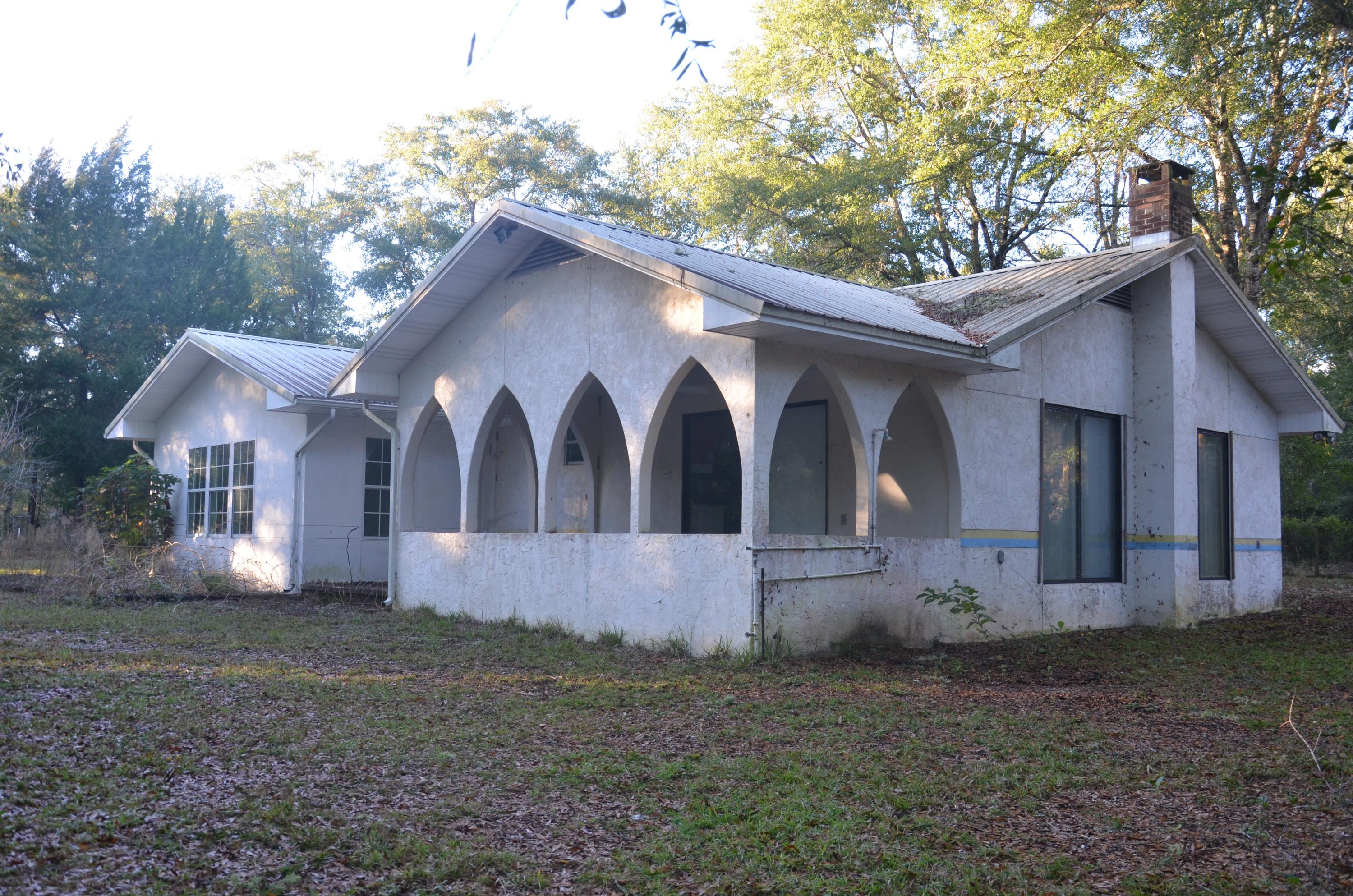Custom built 3 BR 2 BATH, 1900 SqFt home on private 4 wooded acres in Ponce De Leon. Located just North of Freeport this beautiful home was built on a poured foundation, metal roof and custom slate floors. Split floor plan with master bedroom, bath and kitchenette on one side of spacious family room (see attached floor plan). Property features fenced in yard for pets including the two car garage with workshop, small vineyard and center block shed. Property is located 7.5 miles from highway 331, 11.9 miles from Healthmark Regional Medical Center, 14.2 miles from Interstate 10 and 15 mile from Defuniak Springs and its amenities. *all dimensions and features are approximations- buyer to verify all information provided.