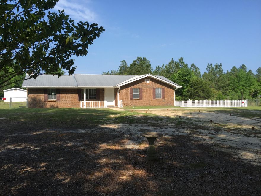 Welcome to your quiet newly renovated home with lots of yard and work/storage space. This beautiful home has soft cool gray colors and laminate wood flooring. The new kitchen has granite counter tops, glass/tile back splash, stainless appliances, including a beverage refrigerator. The electric fire place adds to the cozy atmosphere any season of the year. Entertain with the doors open to the bright Florida Room. Each bedroom has ample closet space; in addition, the master closet feels like a room all itself. You will be at peace in your surroundings inside the house or out. The yard is level with several magnificent trees away from the house. There is plenty of room for a garden, a pool, an RV, recreation or lounging.