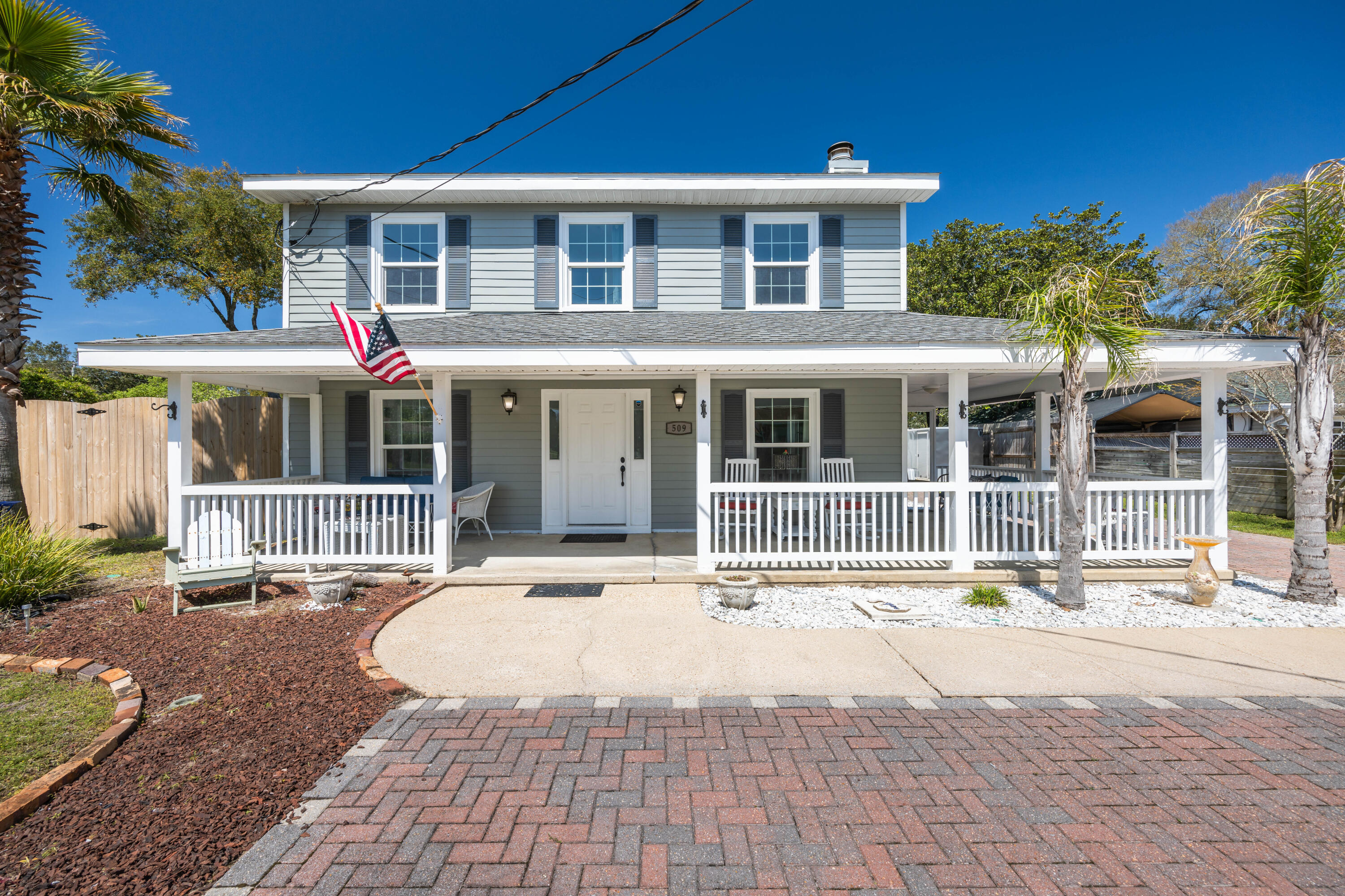 Nestled in the coastal paradise of Destin, FL, this home exudes a vibrant Southern charm fused with the laid-back allure of coastal living. The grand wrap-around porch invites you to unwind and soak in the coastal breeze, offering a taste of the good life.Step inside to discover a spacious Southern-style kitchen, a culinary oasis perfect for hosting lively gatherings or enjoying quiet mornings. Boasting four bedrooms and three and a half baths, including two luxurious master suites, this home is designed for comfort and versatility. The first-floor master suite, thoughtfully positioned for convenience, offers a private retreat ideal for in-laws or guests seeking a tranquil escape. Upstairs, the second master suite boasts elegance and comfort, providing a serene sanctuary.