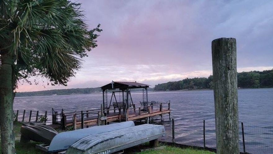 Waterfront home on Paradise Island Drive on  Kings Lake!  This well kept 3 bedroom, 2 bath  home is perfect for dream living! It is like a    mini resort/retreat, worthy of  record size bream, bass and crappie and more.   You can sit on your open back deck, or gaze from your FL Room and watch the sunset each day or just watch the many birds and other wildlife.  Perfect spot to grill and eat near the water under your covered pavilion or the pavilion on the dock.  Pick scuppernong grapes in the summer. So much space on the interior with large great room and kitchen on the front of the home and beautiful master bedroom and bath.  Other bedrooms are just right for kids or guest.   Easy to view.