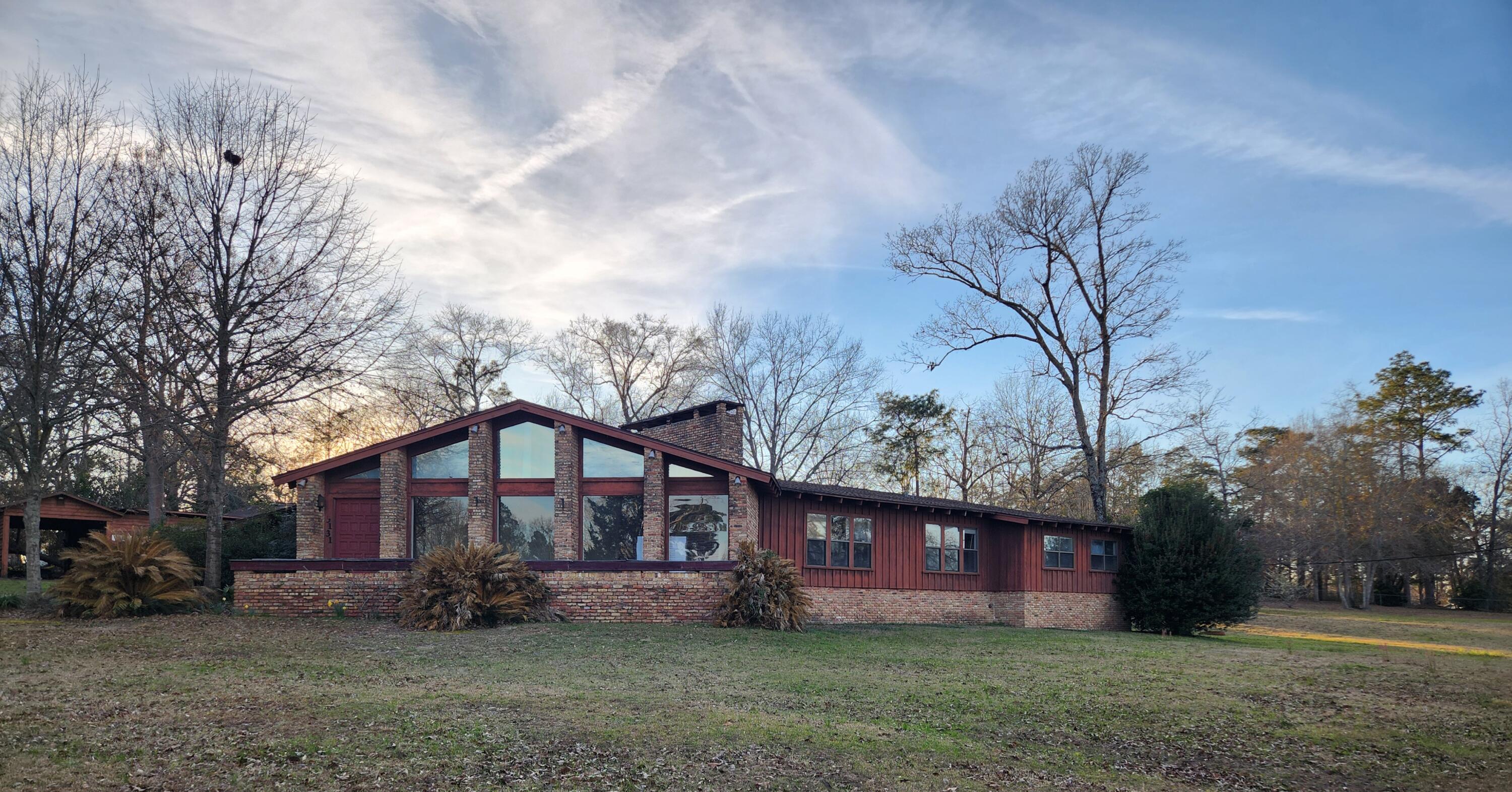 Imagine having a home with 4,405 sq ft heated living space in the country on 3.72 acres overlooking a serene Lake boasting daily sunset views, wildlife chatter, and fresh wood smells. The home needs love, but what better way to convert a rustic canvas into your serene home or vacation Lake home. Home originally built in 1965 with an effective date 1980. Constructed of wood siding and brick this 5 bedroom, 3 bath home offers an investor or family an opportunity to come in and finish / to what the owner started. The home boasts 2 fireplaces, Terrazzo flooring, new LVP, in ground pool, attached carport, an RV carport, and workshop. The materials / appliances currently in home do convey the property.