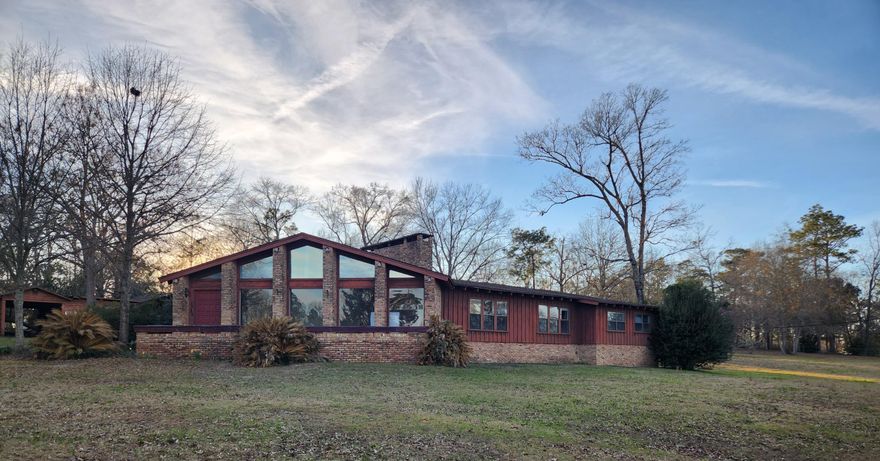 ****HIGHEST & BEST by 9/4 @ 3pm*** Imagine having a home with 4,405 sq ft heated living space in the country on 3.72 acres overlooking  a serene Lake boasting daily sunset views, wildlife chatter, and fresh wood smells. The home needs love, but what better way to convert a rustic canvas into your serene home or vacation Lake home. Home originally built in 1965 with an effective date 1980. Constructed of wood siding and brick this 5 bedroom, 3 bath home offers an investor or family an opportunity to come in and finish / to what the owner started. The home boasts 2 fireplaces, Terrazzo flooring, new LVP, in ground pool, attached carport, an RV carport, and workshop. The materials  / appliances currently in home do convey the property