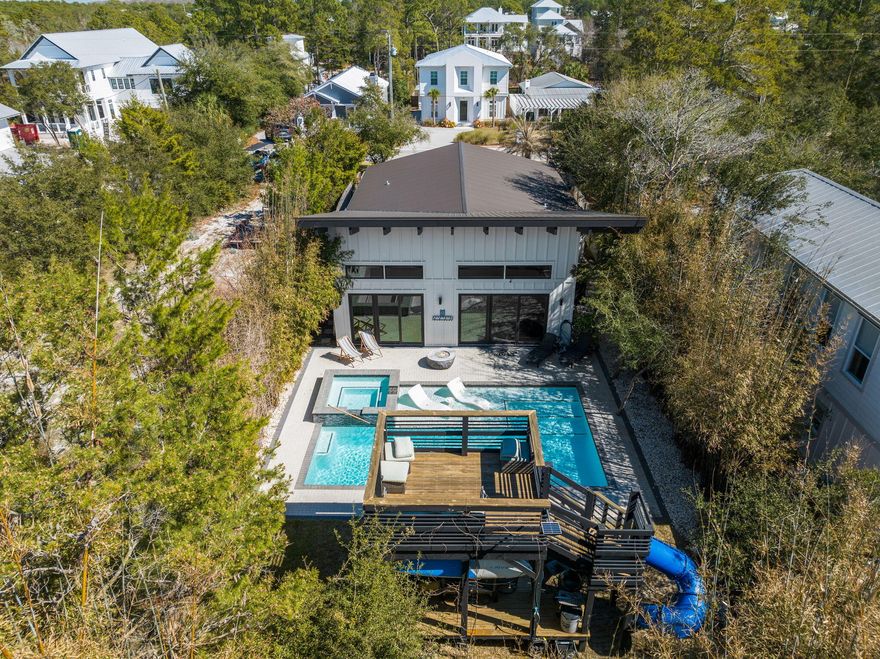 Welcome to 94 S Gulf Drive, a stunning custom-built estate nestled in the highly sought-after community of Seagrove Beach. This extraordinary residence offers 2,060 square feet of impeccably designed living space, featuring three spacious bedrooms and three and a half luxurious bathrooms. From the moment you step inside, you'll be captivated by the grand open floor plan, soaring ceilings, and an abundance of natural light that creates an inviting yet sophisticated ambiance. The living room exudes elegance and warmth, anchored by an electric fireplace, perfect for cozy evenings. The chef's kitchen is a masterpiece, boasting a massive island ideal for entertaining, a built-in ice maker and wine refrigerator, and a spacious butler's pantry to keep everything organized in style.
The sumptuous master suite is a private retreat, featuring built-in dresser drawers in the walk-in closet, a second electric fireplace, and a spa-like master bath with an expansive walk-in shower and steam room. Each guest suite offers an en suite bath and walk-in closet, ensuring privacy and comfort for family and visitors alike.
Step outside into an entertainer's dream backyard, designed for both relaxation and lively gatherings. A sprawling two-story deck sets the stage for unforgettable moments, complete with a children's slide for added fun. Unwind in the hot tub or take a dip in the expansive private pool with a sun ledge, perfect for lounging in the sun. The lush, mature landscaping and towering trees create an exclusive, resort-like atmosphere with ultimate privacy. The storage shed also provides extra storage space for your needs.
Enjoy morning coffee or evening cocktails in the large screened-in front patio, where you can soak in the coastal breeze. And with the pristine beach just a short walk away, you'll have the best of Florida's Gulf Coast at your doorstep.
This exceptional property is the perfect fusion of luxury, entertainment, and tranquility. Don't miss this rare opportunityschedule your private viewing today and experience the ultimate Santa Rosa Beach lifestyle at 94 S Gulf Drive!