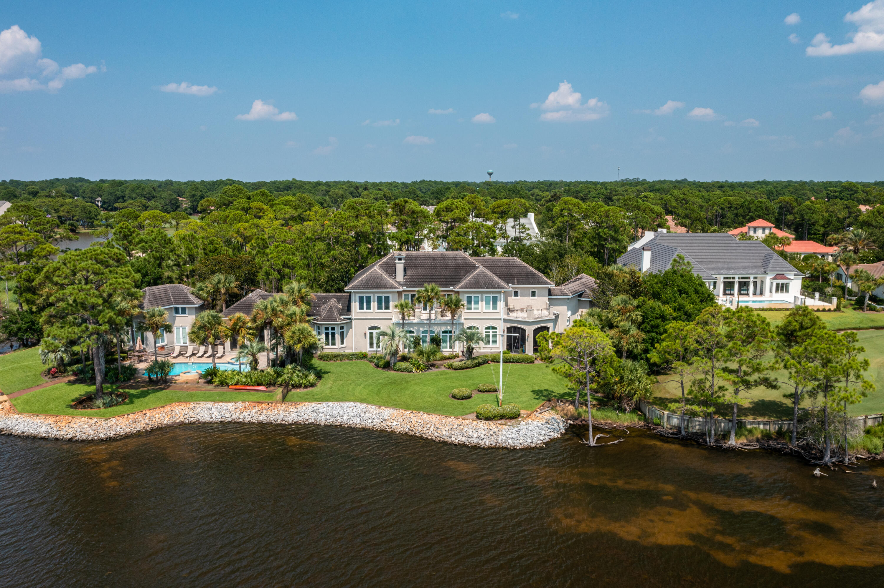 Sitting on almost one acre and bordered by The Choctawhatchee Bay, and 13th and 14th hole of Burnt Pine Golf Course, 3257 Burnt Pine Cove is a  magnificent estate that offers privacy and views that can not be found anywhere else in Sandestin Resort.  Measuring 8856 sqft, the main home features 6 bedrooms, 5 full baths, 2 half baths, chef's kitchen complete with butler's pantry and double dish washers, expansive living area, two dining rooms, media room, office, library, two laundry rooms, 3 car garage, and elevator.  The separate guest house adds an additional bedroom, 2 full bath, kitchenette, and living area.  The outdoor space is sure to not disappoint with 376ft of waterfront, heated pool and spa, two screened  porches, private dock with boat lift and two jet ski lifts.