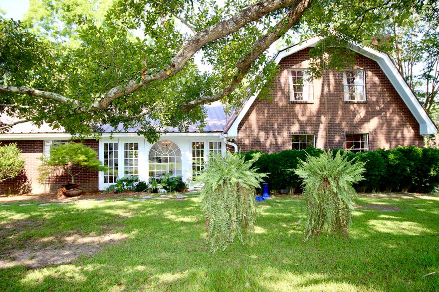 Farmhouse + barn on 3 acres just north of DeFuniak Springs. First, you can't help but notice the amazing custom kitchen cabinets, professional grade appliances including 48'' refrig/freezer, 48'' gas cooktop, granite and butcherblock island top. The cabinet quality is exceptional and if red isn't your thing, could easily be repainted. Built in cabinets throughout create abundant storage. Master bedroom suite is downstairs - 2 beds & 1 bath upstairs with option to create a 4th bed downstairs also. No carpet! All hardwood, tile and laminate throughout. Beautiful garage conversion with walls of windows for amazing light! Who wouldn't want to do laundry in THIS laundry room? With built-in cabinets, farm sink and half bath! You'l love the small picket fenced back yard with deck, stone paths, gazebo and plenty of land surrounding (see aerial views) with no immediate neighbors. Come check it out