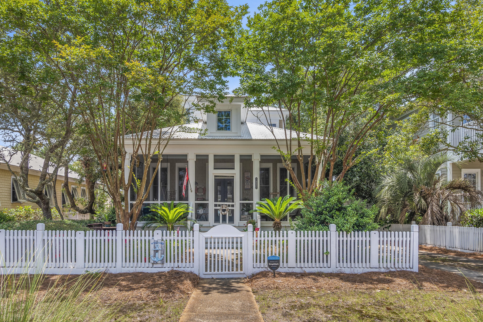This charming three-bedroom, three-bathroom home in the prestigious Frangista Beach community sits directly behind the community pool and bathhouse. It is only a short stroll to your deeded beach access. You will love the serene environment that surrounds this beach house. This Florida beach cottage would be an excellent primary residence, second home, or vacation rental. Its quaint coastal living architecture defines the relaxed culture of the area. A white picket fence frames the house, and a large, screened porch welcomes you to the front door. Inside, you will enjoy the loftiness of the 11 foot ceilings. Rows of beautifully cased Pella windows throughout this home provide natural lighting.