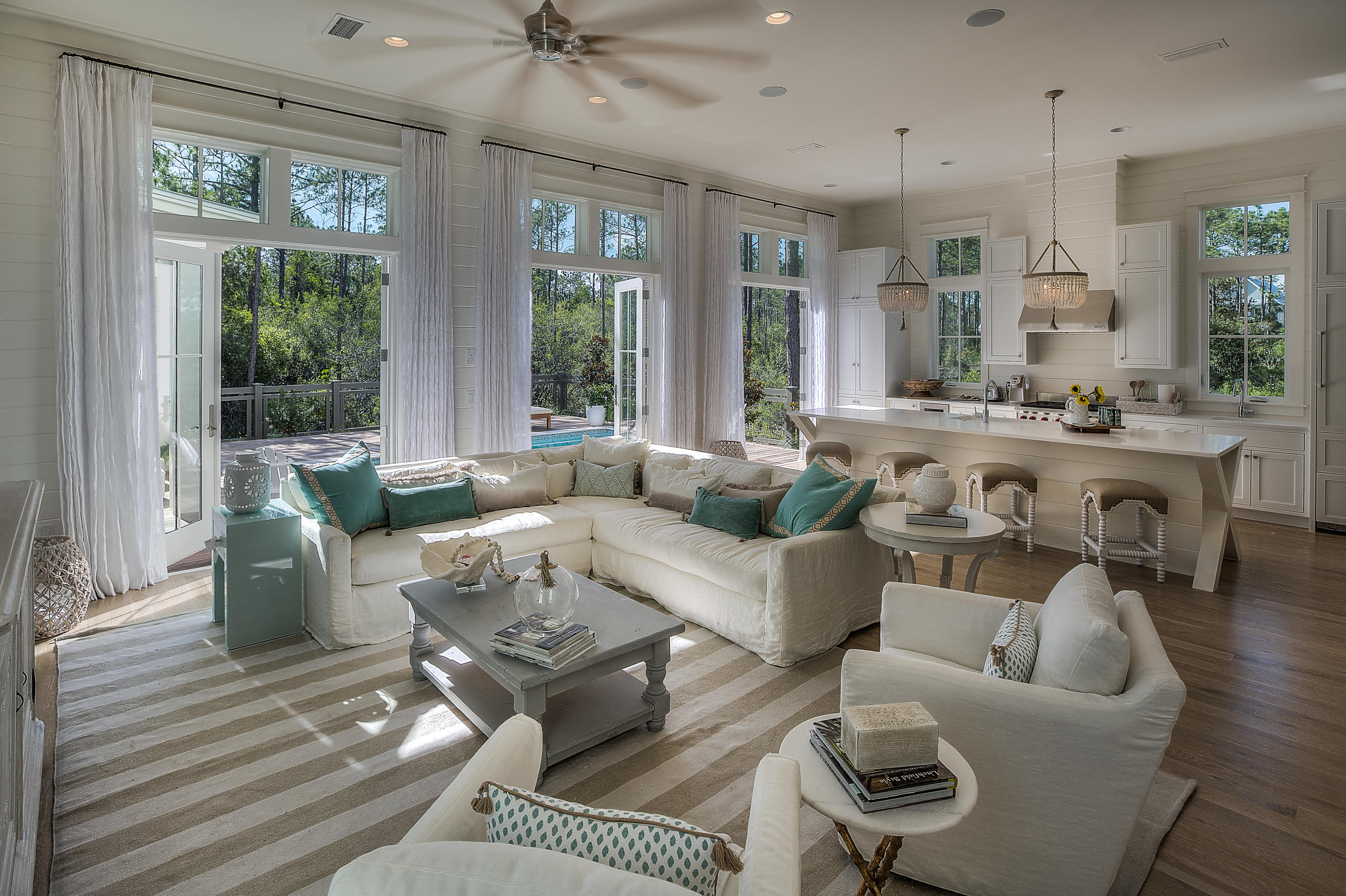 This stunning, fully furnished home was just completed by Romair Construction and is located in Watercolor's Crossing. No detail was overlooked in the design of the home, it's finishes & furnishings. The breathtaking open concept great room offers soaring 12' ceilings, abundant windows, stunning state of the art kitchen & lovely dining area all overlooking the pool & spectacular outdoor living area. The kitchen has white quartz countertops, custom cabinetry, Wolf & Sub Zero appliances including an icemaker & wine fridge. Open the triple set of French doors in the great room and step outside by the pool with spa or relax under the cabana by the outdoor fireplace.