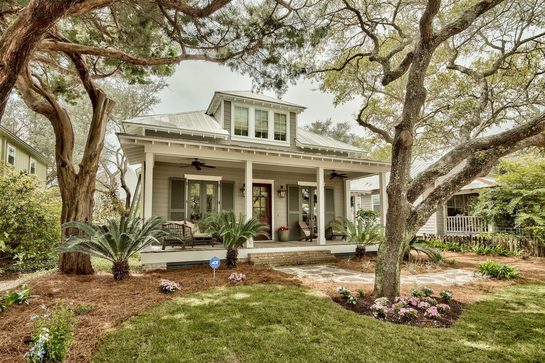 This magnificent cottage welcomes you in with the Bevolo gas lanterns flanking the front door on the large covered porch. Designed by famed Architect, Jack Davis out of Atlanta, this beach property is situated among the live oaks on a deep lot, less than three blocks to the sugary sand beach in Grayton. This property offers an open concept for living with the master and a guest suite on the main. Upstairs has a lovely guest suite, bunkroom with private bath, and a separate den. The reclaimed pine floors, planked wood walls, and white cabinets embraced the essence of Historic Grayton. When you walk out the back door you will find yourself on the perfect screened porch with wood burning fireplace and space for outdoor dining. The backyard offers great space for games & cookouts by the pool.