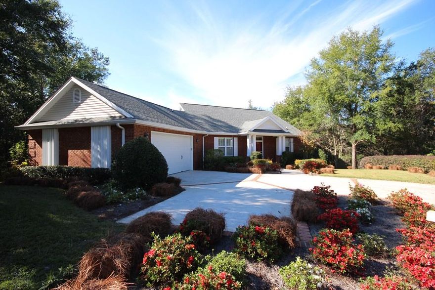 GREAT home in the gated Parkwood Estates community of Bluewater Bay. Built by Key Lime Construction, this home sits on a .42 acre, tree filled, private lot on a quiet dead end street. When you enter this walk out basement home, you will feel like you are in a tree house! The floorplan features the main living areas and master bedroom suite on the street level and office PLUS 2 additional bedrooms and another full bath downstairs on the ground level. The raised ceilings, wood laminate flooring and plantation blinds give this home a light and airy feel. Both the kitchen and family room open to a large screened balcony along the back of the house. The family room is open to the dining room and the eat in kitchen features warm maple cabinetry and solid surface counters. The master suite