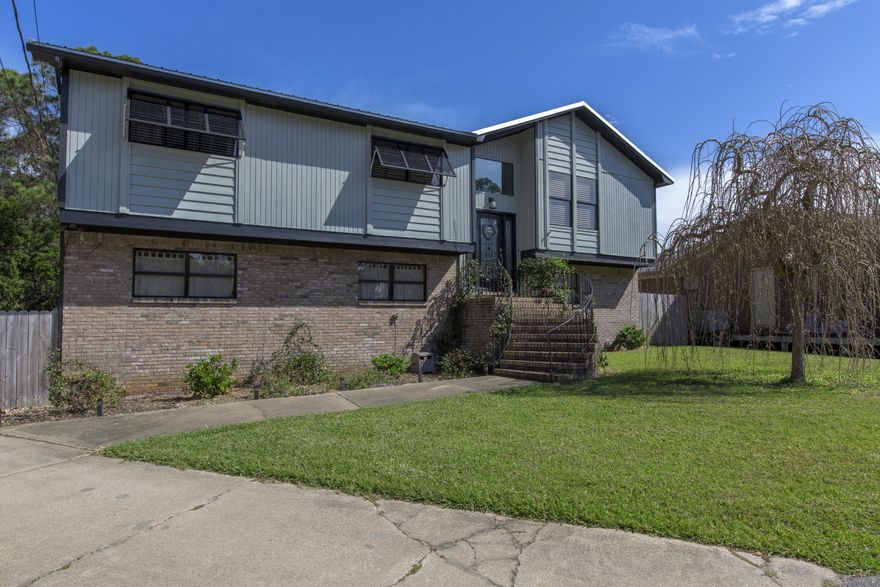 Function and beauty meet in this stunning split level home complete with recent renovations, ideally situated on a cul-de-sac in the Holiday Shores Estates neighborhood of Miramar Beach & just over 650 yards from a bayfront park. Its location is convenient to shopping, dining and entertainment at both Destin Commons to the West as well as Silver Sands Premium Outlets and Grand Boulevard at Sandestin to the East. The exterior of the home features Bahama shutters, glass-pane doors and fresh landscaping. Inside its contemporary kitchen, living and dining room areas are both open and relaxing, and feature hand-scraped hickory hardwood floors which carry onto the staircase. Vaulted ceilings join a gas fireplace in the living room. The kitchen features a custom designed island, Thomasville soft closing cabinets complemented by granite counters and  stainless steel appliances that include an ultra-quiet dishwasher, drawer microwave and down draft range exhaust. The master suite is conveniently located on the first floor and features an outdoor sitting area that offers easy access to the large, 575 square-foot two-car garage. The second floor is home to three guest bedrooms as well as two additional baths, featuring a tub and a shower, one with recent vanity and granite counters. French doors lead out onto a partially screened porch on the second floor that overlooks the fenced backyard. Additionally there is a new standing seam metal roof, geothermal HVAC System & the garage is heated and cooled. Please note that the actual square footage is different than that reported by the property appraiser. Don't miss your opportunity for a lovely updated home at a great price in Miramar Beach. Call and schedule your viewing today. Potential buyers or their Agents should confirm all information to their satisfaction.