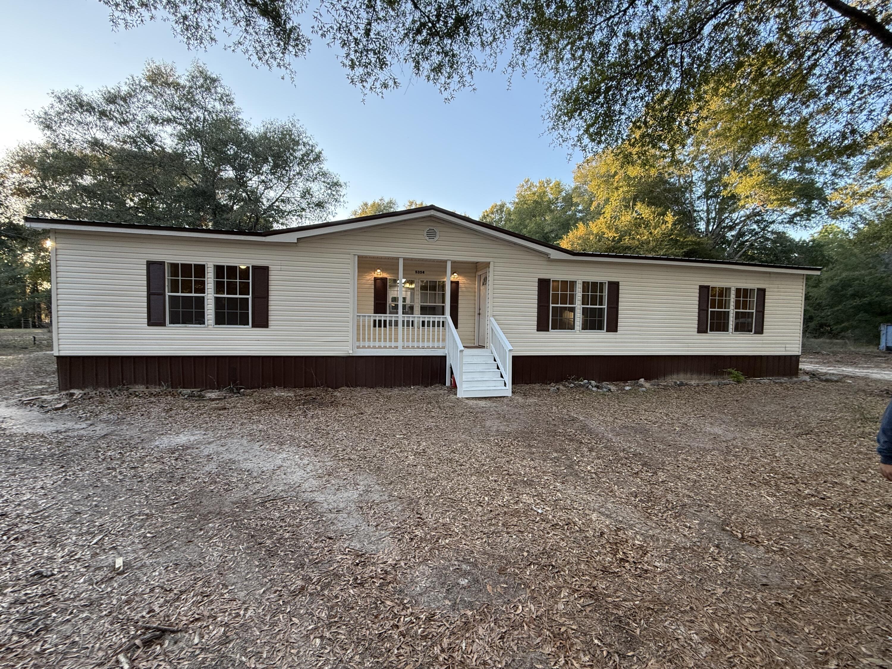 Situated on a one acre lot, this beautifully updated 3 bedroom 2 bathroom home is only awaiting one thing...you!! You are greeted by an adorable front porch where you will want to spend many nights in a rocker enjoying the view and tranquility. Come on in and you will see this spacious home delights with all new floors and  a layout that is perfect not only for day to day living, but also for entertaining. Generously sized living room leads into the kitchen that has been tastefully updated with white cabinetry, stainless steel appliances, and gorgeous countertops. There is a formal dining room that is conveniently located just off the kitchen. Master bedroom features an en suite complete with freestanding tub, double vanity and walk in closet. Two additional bedrooms with large closets and an additional bathroom complete the interior of this home. The back of the home also has a new porch! Don't miss out on this one!