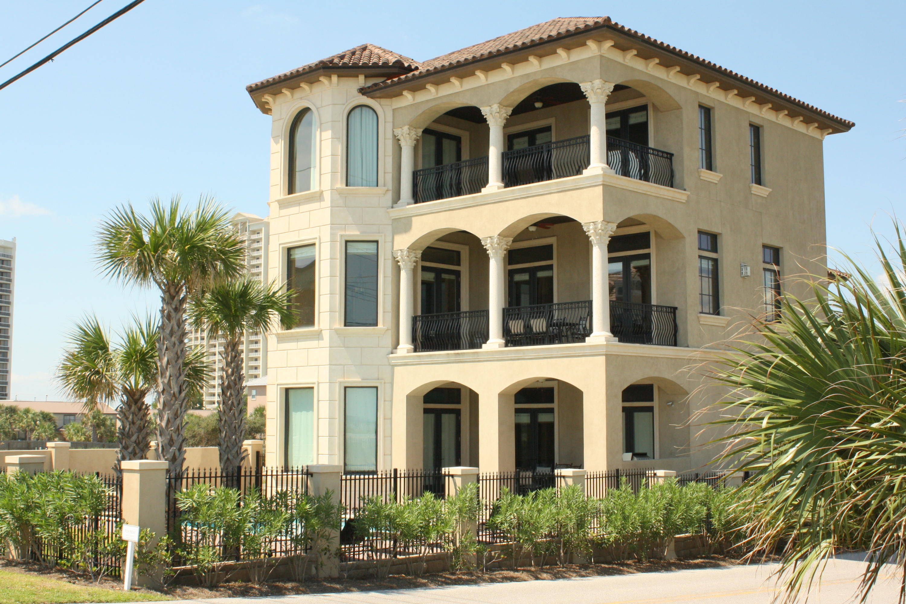 Fabulous Gulf view home, directly across the street from the beach with unobstructed views! ICF poured concrete construction with tons of upgrades and custom features including ruffled travertine floors, raised ceilings, trayed ceilings, crown molding, venetian plaster walls, stone showers, vessel sinks, granite counters, professional grade stainless appliances, elevator and more. First level has family room, complete with pool table, wet bar and fireplace, one bedroom, a bunk room, and access to the covered patio, summer kitchen and large, sparkling pool and spa. On the second level is an open leisure room/gourmet kitchen/dining area which opens to a large balcony, one master suite and a powder room. The third level has the grand master suite, two additional bedrooms and two