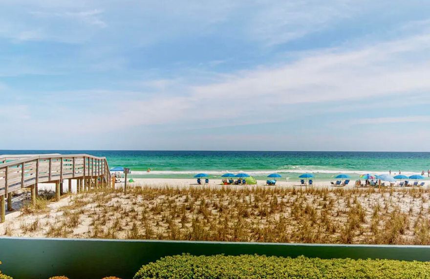 FABULOUS GULF FRONT END UNIT w/ GORGEOUS VIEW OF DUNES & BEACH! FANTASTIC RENTAL INCOME! So far grossed over $45K in 2021 (w/3 months for owners use that included spring break weeks). This end unit has a beach house feel as the white sand & green Gulf waters are just steps away. Parking area is also very convenient. The entry invites you in through a nice foyer area that creates a private welcome. This unit is very spacious and the foyer opens to a bright, airy living area w/ Lg balcony overlooking Gulf completed w/tall bar height poly resin Adirondack chairs/table & a wooden lounger for afternoon nap time . BRAND NEW  Hi-quality Luxury vinyl plank flooring w/random size planks in main & wet areas. NEW Stove, Microwave & Refrigerator. NEW shaker door cabinet faces. NEW paint. Kitchen