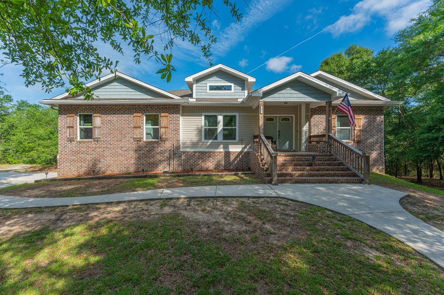 Expansive sprawling home with a clear spring-fed creek on MORE than an acre.  Custom built flowing over 2 levels, upgrades galore. Brick and sided craftsman style with wide inviting porches; for calm mornings and evenings surrounded by nature and birdsong.  Ultra-private feel, the laying chickens can stay! Kitchen is dreamy and huge. Yards of granite tops, copper farmhouse sink, touch-free stainless appliances, farm-door pantry, 42 inch upper cabinets.  Laundry room features built-in cabinetry, granite top, room for a freezer and is sunny and bright. Two living rooms, 5 large bedrooms PLUS bonus office, 3 full baths and additional 1/2 bath for guests. Split floor-plan, master suite is on the primary floor, along with 2 additional bedrooms with a jack-n-jill bath, and additional 1/2 bath. Home has walk out basement style lower floor with additional living/flex, office, 2 bedrooms and full bath.  Modern stained woodwork, wood inlaid trey ceilings, ceiling fans, exterior fans, exterior shower, RV 50 amp plug and parking.  Bonus size garage with additional 15x 17 garage workshop. Two A/C units, whole home water filter, 80 gallon Water heater, Spray-foam insulation, underground utilities, French drains, no carpet and natural landscaping make this home a low-maintenance dream! NO HOA

