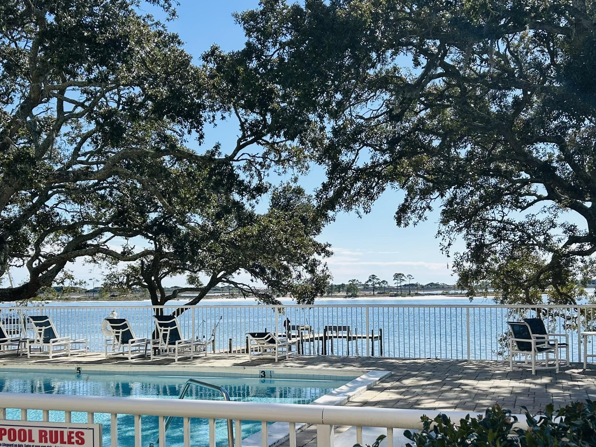 Check out the stunning views from the beautiful community pool! Relax in the shade of the trees, take a dip in the pool, a walk down the pier, or a paddle on the intercoastal or bay. After your day in paradise, retreat to a fully updated one bedroom, one bathroom sanctuary. Complete with balcony and storage for enjoying the outdoors from the privacy of your own condo.Upon entering the condo, you'll notice durable wood look floors in the entryway and spanning through the kitchen, brand new carpet and wide sliding glass doors to the balcony. In the kitchen you'll find brand new, solid wood cabinets, new laminate countertops, as well as a new sink and faucet with updated light above. (Cabinet hardware will be installed). The open floorplan between the living and dining area offer multiple options for furniture layout.
The bathroom has a brand new sink, vanity and mirror, making it a great spot for a relaxing shower after the perfect day enjoying the beautiful Florida weather.
The complex also includes elevators and a community room with kitchen, bathroom, tables and chairs, comfortable seating and a TV.  Down the hall from the community room, you'll find the laundry room - complete with ample machines, tables for folding your freshly laundered items, chairs and a vending machine in case you need a snack.
The Cedars is short term AND long term rental friendly, so investors take note! This condo is also extremely close to Hurlburt Field and the Industrial Park in Ft. Walton- making for an easy commute if you decide to keep this gem for yourself.