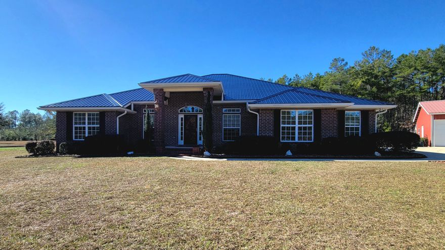 Gorgeous country estate with an all brick home with  +/- 9  acres with 4-5 bedrooms (office space). This home has over 3000 s.f. of heated and cooled living area.  As you enter the foyer it welcomes you with natural colored/upgraded tile flooring with formal dining room on the right and office on the left.  The great room has great architectural features, vaulted ceiling, hardwood flooring, recessed lighting.   Kitchen has stainless steel appliances, cherry wood cabinets, large island, pantry, granite counter tops and large breakfast bar and breakfast nook area overlooking a beautiful gunite ion enclosed pool with a  3-5' depth and new pool pump with transferable warranty. Home has a brand new metal roof installed Dec. 2022.  Property includes raised vegetable/flower  boxes...Click MORE Home has a large 20x16' master bedroom with 2 huge walk-in closets. The oversized jetted garden tub is ready for relaxing.  A double-headed separate shower.  Master bath has separate double vanities-with beautiful tile work,  a separate dressing vanity area and a private commode closet. The master bedroom opens to the covered back porch and the enclosed pool.  Two of the other bedrooms have large walk-in closets.  The office room may also serve as another bedroom if needed.  Home has 3 linen closets.  The laundry room has a built-in counter that is perfect for sewing or folding laundry.  This home has a 2 car attached garage  20'x22' with a pull-down ladder for attic access.  A tall pole barn 16'x48'  RV barn with a 30 amp box; a 32x40' workshop (1280 s.f.)  with electricity and water; a Gazebo 10x12' with electricity to relax and enjoy nature in your own private place (swing not included).   The acreage has been cleared for pasture.  Property has a deep well.  The land is  surrounded  on the South side and East side of the property (2 out 3 sides)  by Conservation Land that provides a great area for the shooting mound at the back of the property.   Entrance to the property has black iron gates and an asphalt driveway.  You are only 20-25 minutes to South Walton and Destin beaches and Panama City Beaches.  This is surely country living at its best.