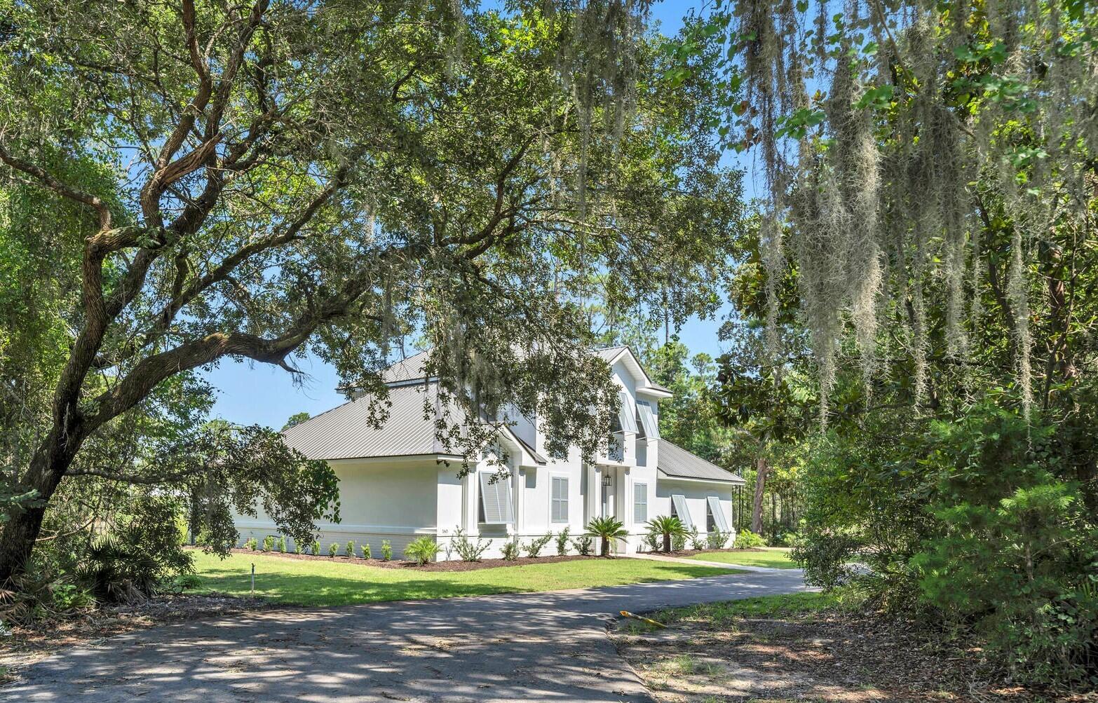 This stunning bayou-front residence in secluded Botany Bayou is the waterfront oasis you have been waiting for! Mature live oaks and lush landscaping lead to this impeccably renovated retreat. High end finishes abound in the chef's kitchen, complete with GE Cafe appliances and custom tile work. The open floor plan living space includes a fireplace and views of the bayou. A formal dining room accentuated with architectural ceiling detail is also waterfront and features a pocket office. The waterfront primary bedroom boasts amazing views, a spa-like bathroom and his and hers closets. The incredible boat house boasts power, water and upgraded lift along with a sunning/fishing deck. Upstairs you'll find two additional bedrooms, a custom jack-and-jill bathroom and large laundry room.
