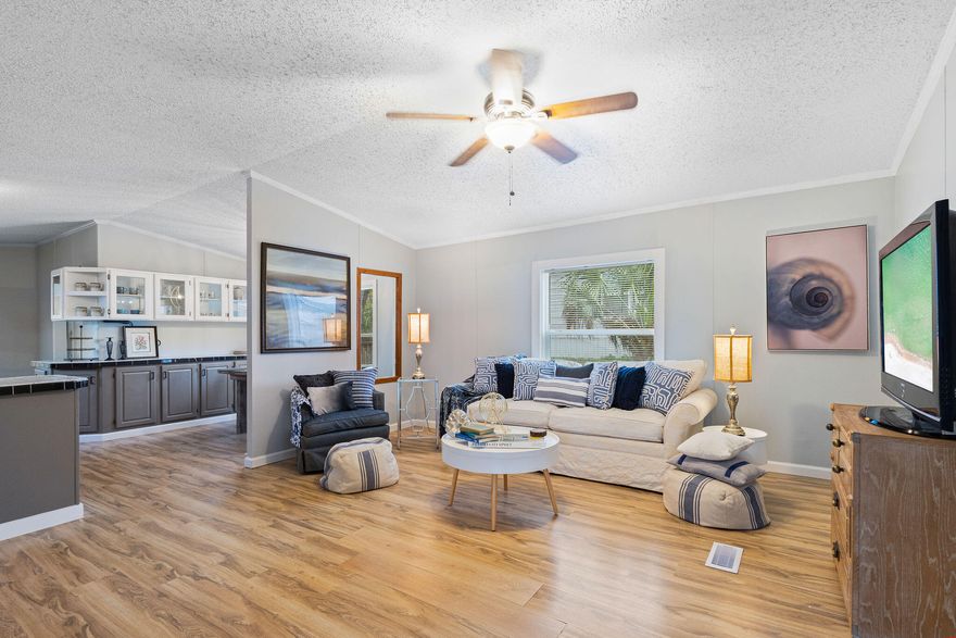 BOUGIE ON A BUDGET! Epic Location & Epic Price! Looking to live in Bayside and experience the most glorious sunrises in Panama City Beach, but at a fraction of the cost? Well look no further... Welcome to your new home at 6906 Sunrise Drive. This beautiful beach cottage comes FULLY FURNISHED with the most stunning coastal decor and is truly move in ready! This spacious 3 bedroom, 2 bath home is a perfect vacation getaway, primary home and even fabulous for short-term and long-term rental opportunities. Nestled across from the canal with water views, this home is perfect for boat owners, located only 1/8 mile from the marina offering affordable boat storage and launch options. If you need a break from the bay and looking to dip your toes in the sand you are only a 5 min drive to the beach!