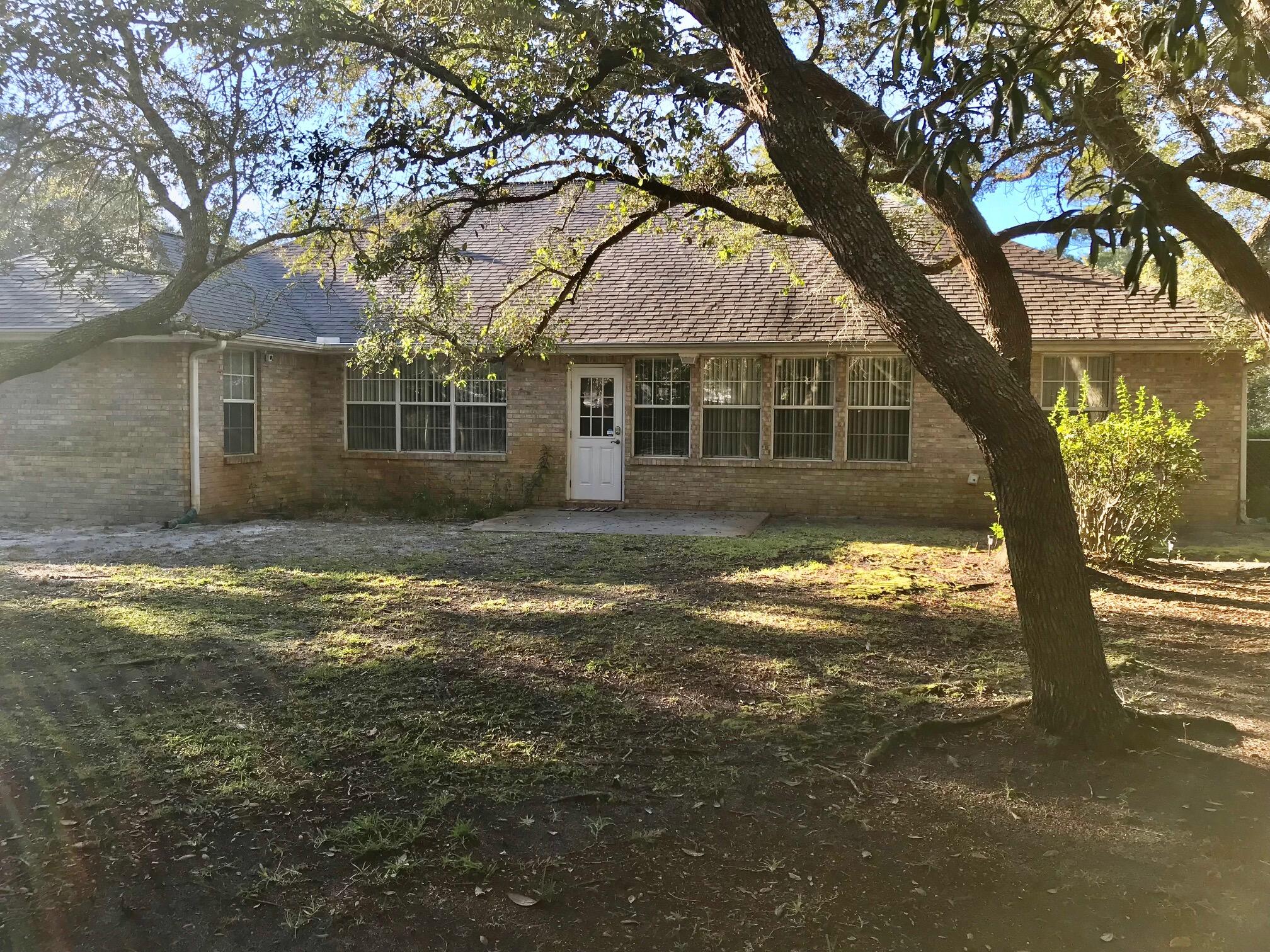 THIS HIDDEN GEM AND RARE FIND is in a Florida natural setting! A well built brick home on a spacious lot in the heart of Destin! NO HOA, NO FLOOD INSURANCE REQUIRED! This .69 acre lot has room to build a separate mother-in-law's quarters, an RV shelter or bring your boats! This home with split bedroom plan has a large master bedroom, oversized bathroom and walk-in closet plus linen closet as well as two bedrooms and bathroom separated by a living room with vaulted ceiling and skylights. A gas fireplace and built-ins in the living room add to the detail of this home with charming arch doorways throughout! A separate dining room is included plus a bonus room and sunroom which can be used for exercise room or office. The natural park-like fenced back yard adds to the outdoor living space.