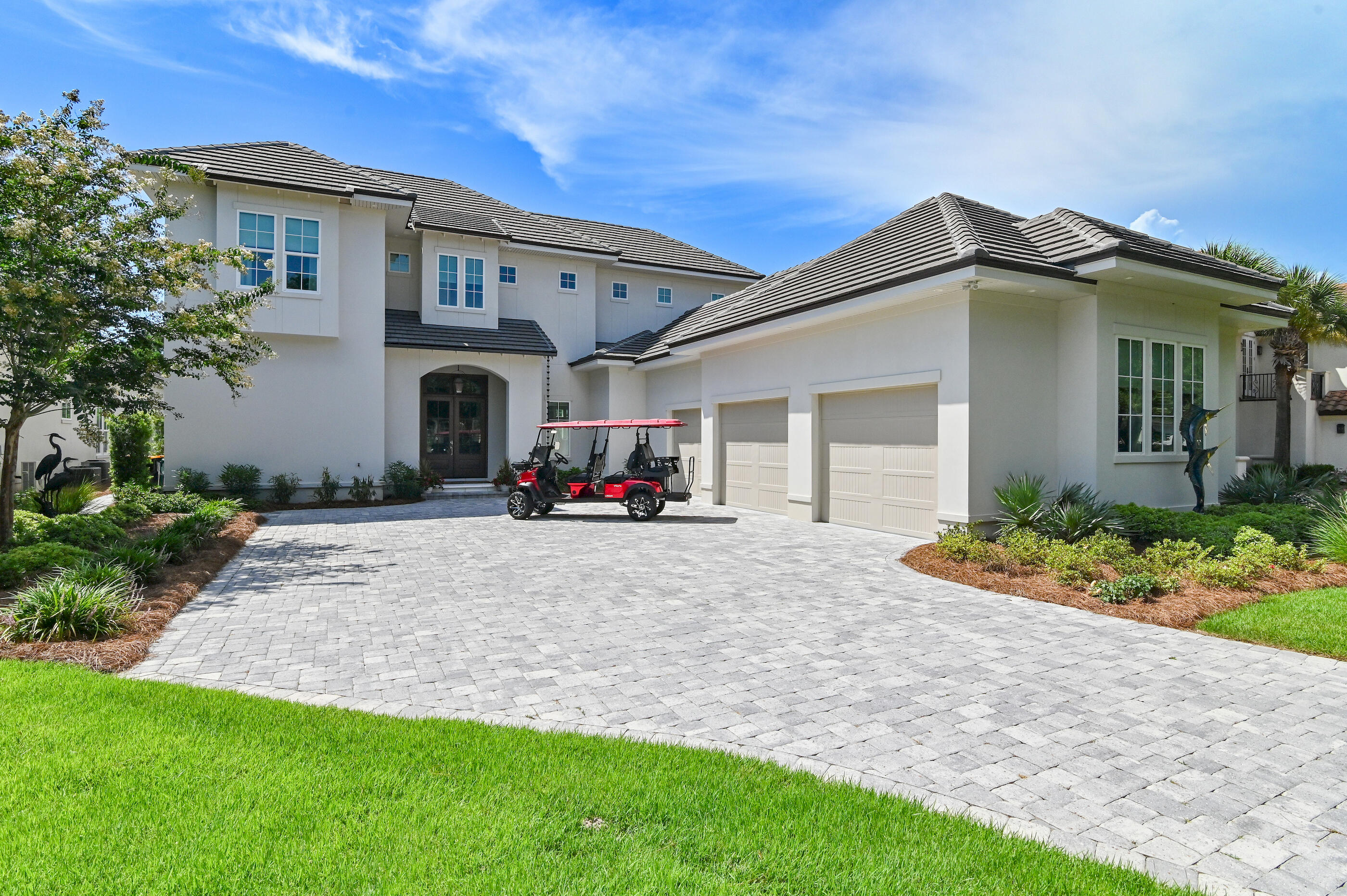 Welcome to 298 Corinthian Place, where elegance meets tranquility in this prestigious gated community of Regatta Bay in Destin, Florida. This custom-built masterpiece offers a premium lot on the 13th hole of the golf course, complete with a serene pond view, catering to the discerning buyer seeking luxury, privacy, and breathtaking vistas.As you approach, the home's striking facade and meticulously landscaped grounds offer an immediate sense of grandeur. Step inside to discover the expansive entryway, seamlessly connecting you to the main living areas where high ceilings and abundant natural light create an inviting and sophisticated atmosphere. The gourmet kitchen, a culinary enthusiast's dream, double quartzite islands, stainless stainless steel SubZero and Wolf appliances, ice maker, wine refrigerator, two sinks, multiple prep areas, and bespoke cabinetry. It's perfectly designed for both intimate family gatherings or entertaining.
Retreat to the sumptuous bedrooms, each thoughtfully designed to provide a private sanctuary, while the spa-like bathrooms offer a haven of relaxation with their luxurious finishes and fixtures.
The outdoor oasis is unparalleled, with a stunning pool and lounge area perfect for unwinding while enjoying the sunset over the pond. This space is designed for both relaxation and entertainment with an outdoor kitchen, dining area, outdoor media nook, and retractable sunshield screens providing an idyllic backdrop.
1. Premium golf course lot with pond view
2. Custom builder features and high-end finishes
3. Stunning outdoor pool and entertainment area
4. Spacious, light-filled interiors with high ceilings
5. Gourmet kitchen designed for culinary excellence
6. Gated Community one of the top-rated golf courses along the Emerald Coast of Florida
7. Whole house generator
8. Heated and Cooled three car garage with lift to attic space
9. Astro turf in the fully fenced back yard for all of your furry friends