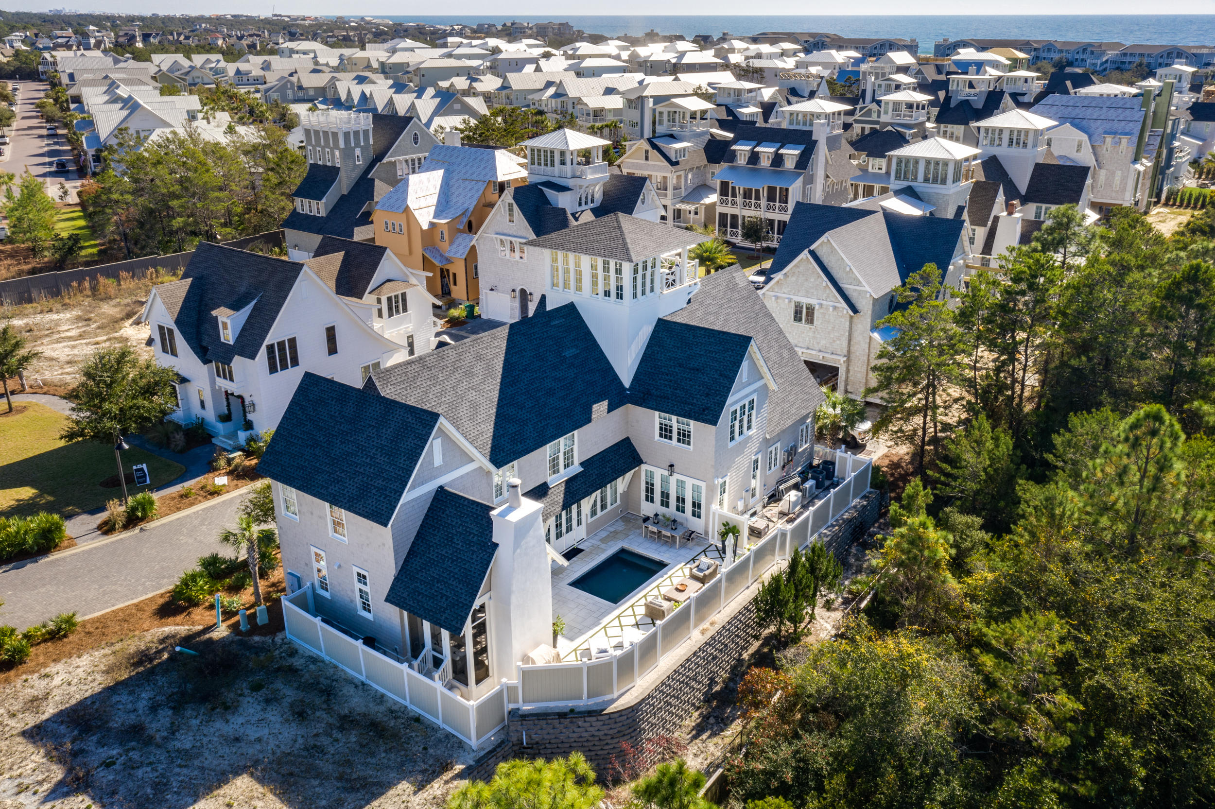 This exquisite home is located behind one of 30A's most exclusive gated boutique beach communities, Grace Point.  The home backs up to a very private wooded area and has a luxury private heated, saltwater pool with fountains and color lighting to create a outdoor resort experience.  There is a gate with code access directly from neighborhood into Watersound Beach Club so you really do have it all here. As you enter this stunning three story home you will be welcomed by eloquent craftsmenship with unique luxurious finishes.  The open living area on the main floor allows family and guests to share the living, dining and kitchen area for relaxing, cooking and dining together.  The rooms are light and bright which creates an upscale beach feel that 30A is known for.