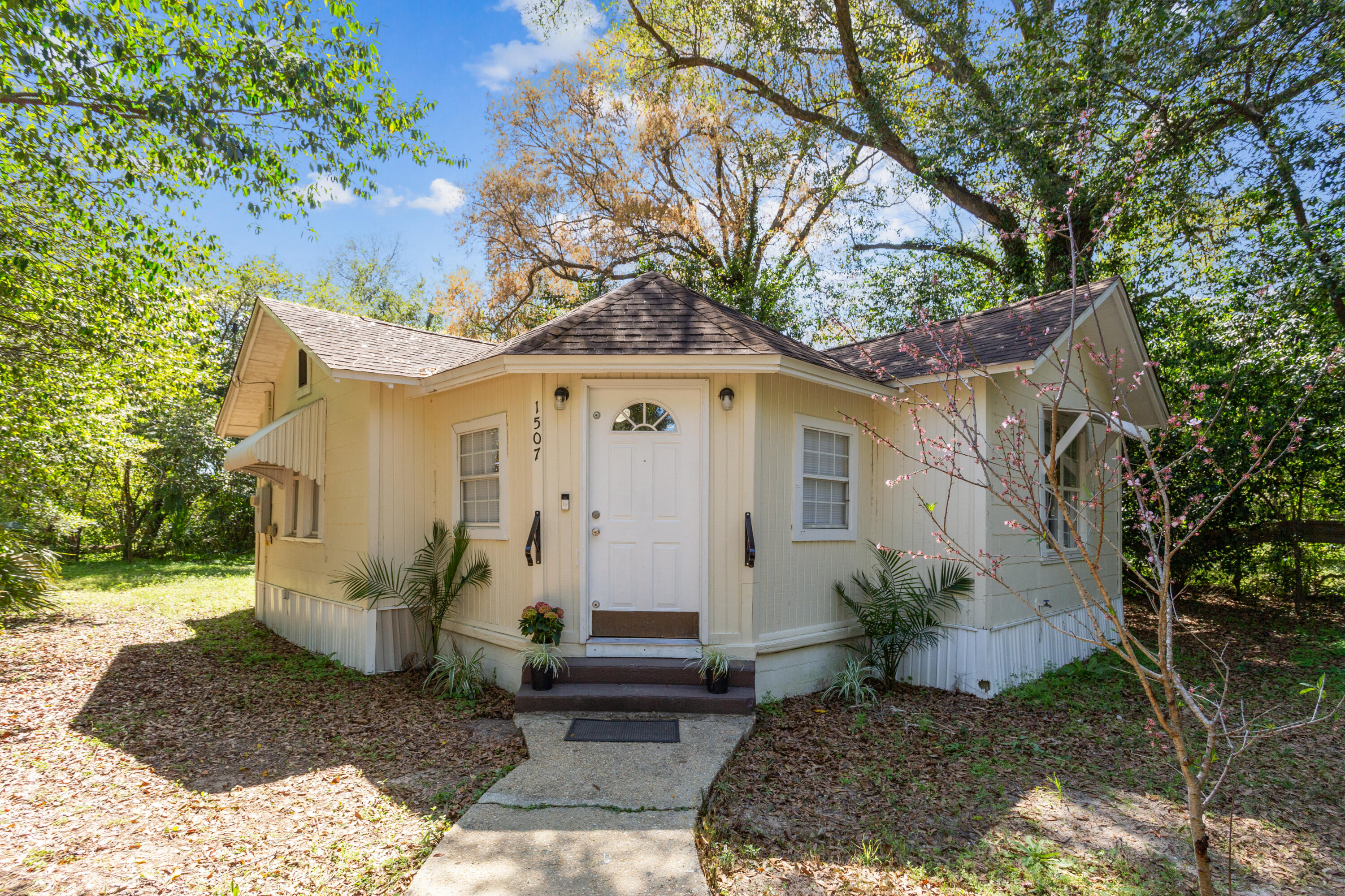 Welcome to this adorable cottage, freshly painted inside and out, and ready for its new owners! Situated on a large, private corner lot, this home offers a cozy and functional layout with plenty of possibilities. Inside, you'll find a bedroom with a closet, as well as a versatile flex room on the opposite end of the home--perfect for use as a second bedroom, office, or hobby space conveniently near the laundry area. Enjoy the peace of mind that comes with a 2016 roof, a 2023 Condenser, 2024 Handler and brand new 2025 Water Heater! Natural light pours in through the new blinds, complementing the fresh paint throughout. The wood-like vinyl plank flooring gives the home a modern and low-maintenance appeal. Outside, the fenced corner lot offers plenty of room for outdoor activities or gardening. Just minutes from downtown Pensacola, beautiful beaches, and local amenities. Effective Year: 1980.
