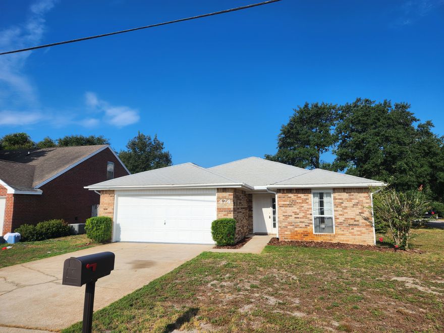 Welcome home! Charming brick home for sale in desirable Mary Esther. This adorable home sits on a large corner lor and features a large front yard. Inside you will find a custom tile foyer, which opens up to a spacious living room with tall ceilings. Just off of the living room is the kitchen, complete with a dining space and breakfast bar. Laundry area located off of the kitchen, which opens up to the large two car garage. Back yard access off of the dining room, which features a back porch and open patio. Spacious primary suite with large walk-in closet. Off of the living room you will find two spare bedrooms and a full bathroom. Split bedroom layout for added privacy. This stunning home features fresh paint, new stainless steel aplliances, and new carpet throughout.