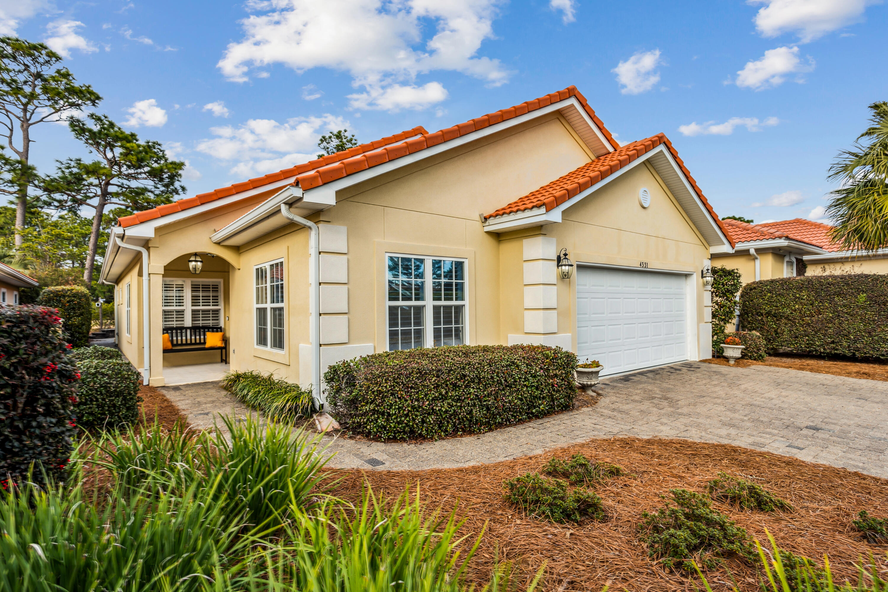 This home is in the highly sought-after gated community of Sunset Beach.  Features include security system and surveillance cameras, tile floors throughout, plantation shutters an updated kitchen  with quartz counter tops and island with stone backsplash.  Black stainless steel appliances.  Back porch is enclosed with hurricane impact windows and is fully climate controlled.  Porch, living room and master bedroom overlook the beautiful fully paved back yard and the 7th Fairway of the Marsh Golf Course. The two car garage is climate controlled. Two parking spaces in driveway. Amenities of the SSB community are clubhouse, private beach, a beautiful bayfront pool and one round of golf monthly.