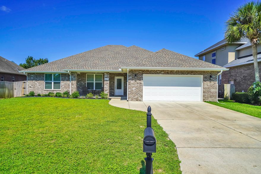 Welcome home to this absolute stunner in North Navarre. Between the beautiful finishes and lovingly maintained condition you won't need to lift a finger to make this the perfect home, it's already there. The curb appeal of fresh landscaping, brick exterior, and inviting front porch says it all. Complete with 4 bedrooms and 3 bathrooms this tri-spilt floor-plan ensures room and privacy for all. The yard features a large covered patio with fans, gutters for rainy days, a new irrigation system, and a large flat lawn begging for a pool or your pups. Enjoy the enormous kitchen, dining room, and pantry which is laid out perfect for daily life and entertaining. The high ceilings, crown molding, custom finished doors, and more bring a classy and luxurious feel to the home.