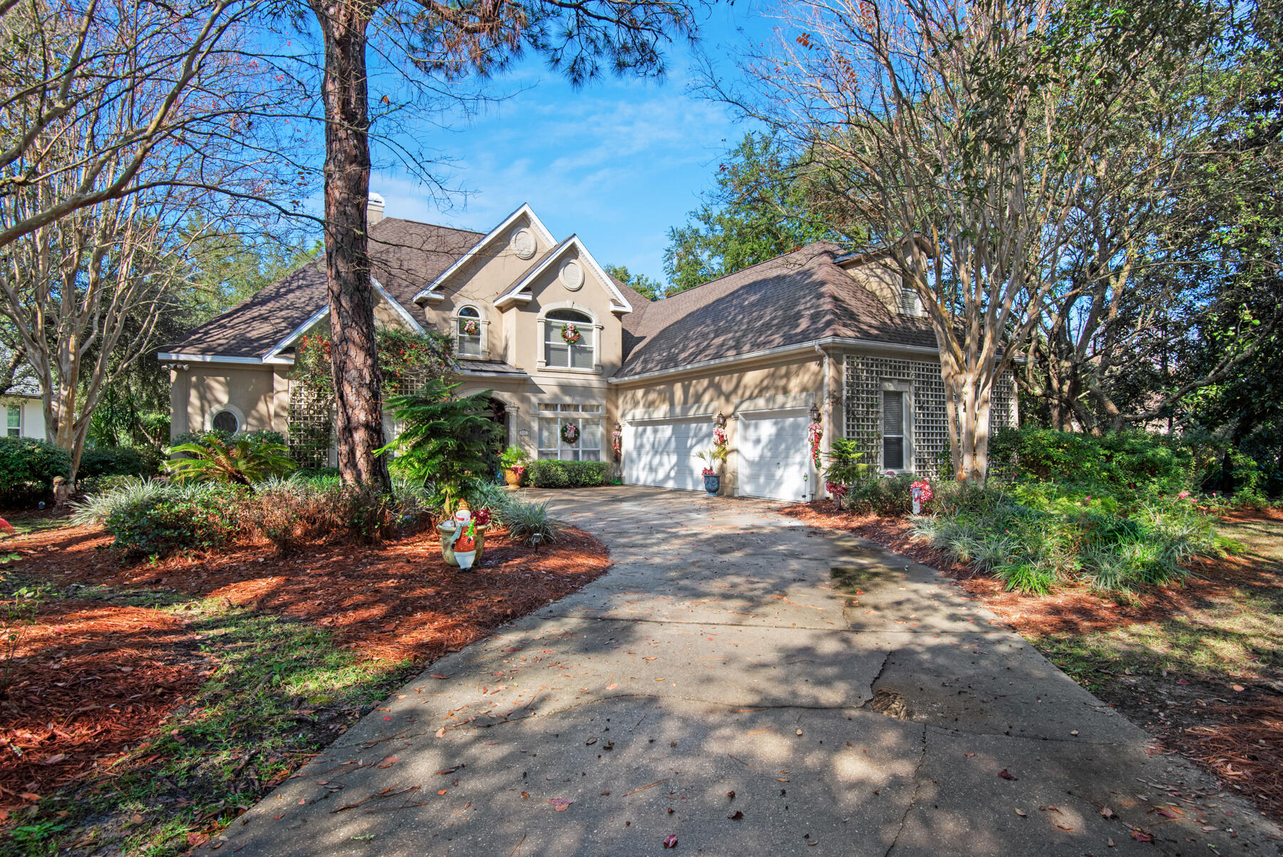 Like the iconic Grace Kelly, 237 Mattie's Way in the popular Kelly Plantation offers classic beauty, understated luxury, timeless style and a touch of French Provencial charm. The 4 bedroom, 6 bath home is set back dramatically from the road and encircled with moss draped, towering oak trees and lush landscaping that give privacy as well as shade, no matter the season. From the foyer, columns to the immediate right delineate a formal dining room while a wetbar (butler's pantry) provides storage and secondary access to the combination living room and kitchen. A secondary, more formal seating area lies across from the foyer where plantation shutters give privacy to the poolside oasis just beyond the back door.