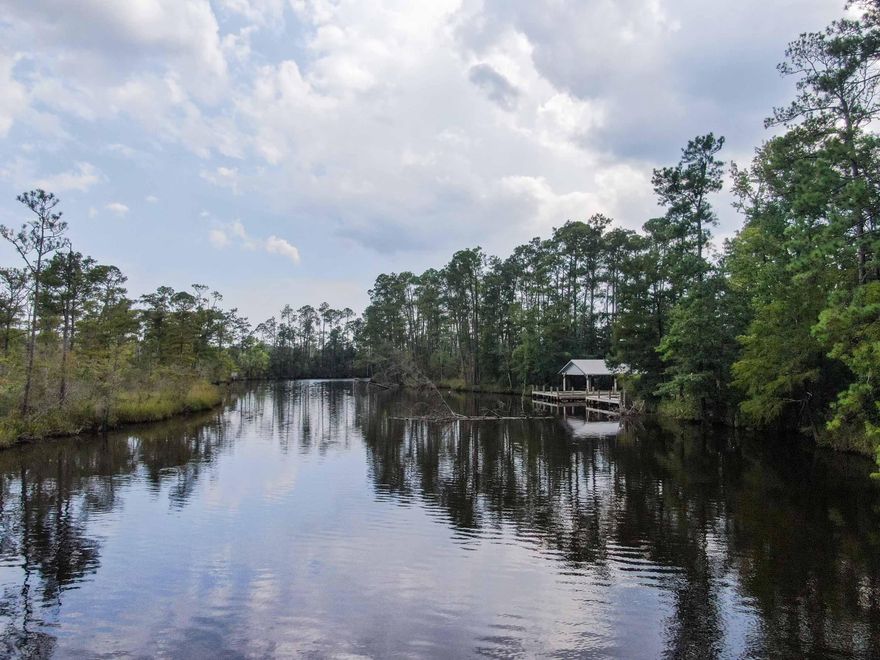 Hurry hard to find a waterfront lot on Alaqua Creek, a fresh water tributary that runs directly into Alaqua Bayou and Choctawhatchee Bay. Excellent fishing for bass, bream, shellcracker, red fish, speckled trout and flounder!  county boat ramp less than a 100 yards from subject property. Deep water.   15-18 feet deep off the dock. No  problem accessing the bay.  At the lowest point in the channel going from  bayou into the bay the depth is estimated to  be  4 feet. Adjoining W.F. lot #9 is also listed & is for sale for $150,000.00