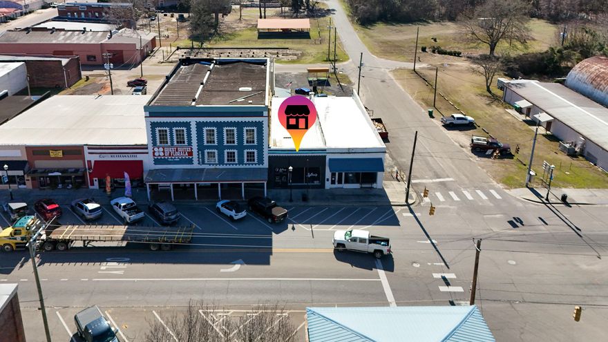 LOCATION- just 1 building over from the main intersection of 331 and Hwy 55 in Florala this 2000 sqft building welcomes all the Beach traffic and visitors coming into town! Remodeled in 2021 this space was turned into an Air BNB for many years. Commercial building offers a large open front office space, a full bathroom, amazing personal offices in the rear of building as well. Property offers a great open floor space for retail while the rear of the building is immaculate! Exposed brick walls, fireplace, and hard wood floors add to the amazing remodel! The exterior of the building offers a great patio area as well as a hot tub from previous use as an Air BNB! The protentional in this commercial space is endless! Call today to see this - live in the back and work from the front!