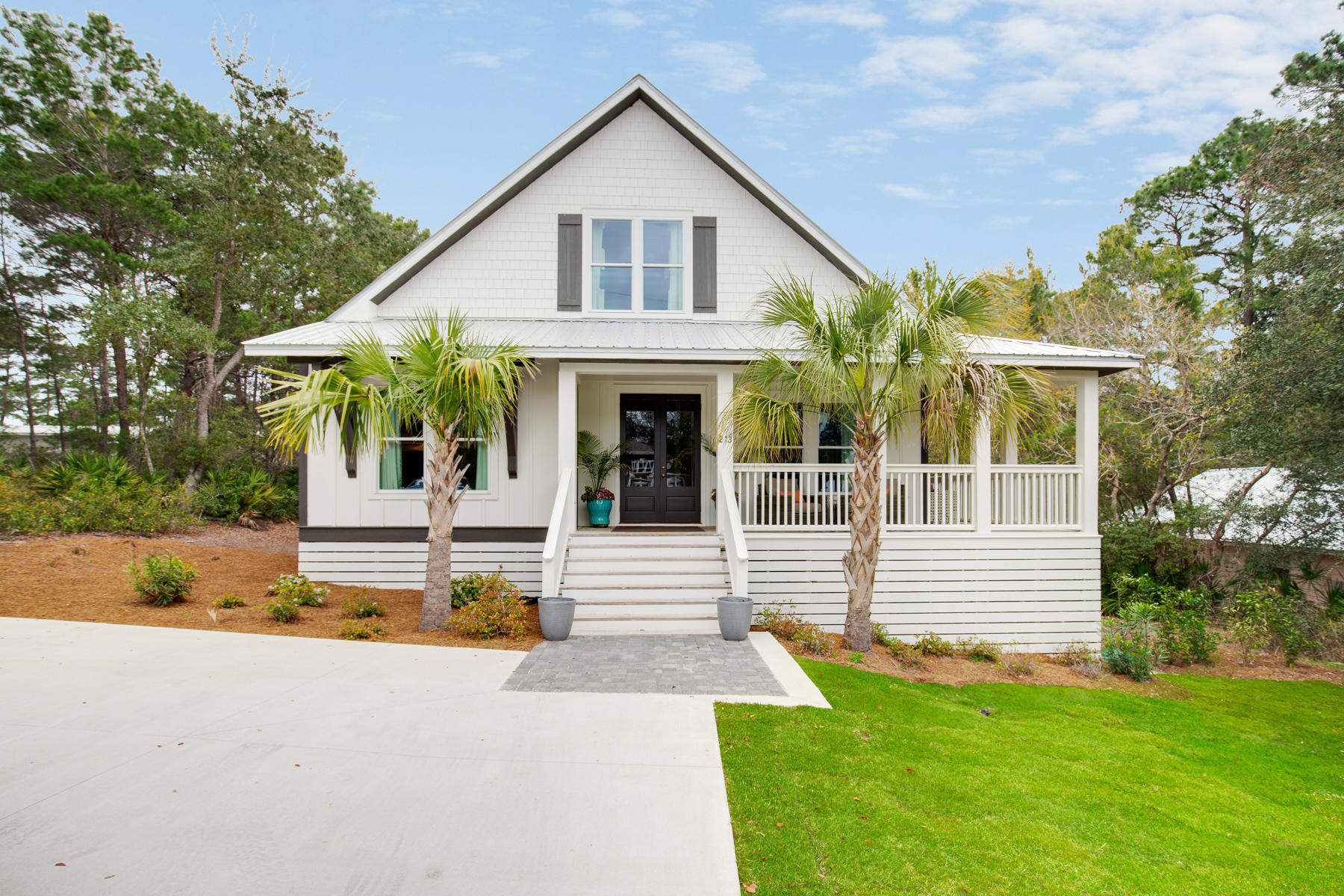 Unmatched quality in this price range for an amazing 1920's farmhouse at the beach! Originally built in 1925 in Andalusia, Alabama, this timeless 4BR/4.5BA cottage-style home was transported to Blue Mountain Beach and then fully restored & renovated in 2016. The exterior restoration included a new foundation, new electrical & plumbing systems, floor joists and high impact windows. The complete interior renovation incorporated a modern design plan with coveted features such as Pecky Cypress beams, shiplap walls, side sewn pine floors, floor-to-ceiling kitchen cabinets, a luxe marble tile master bathroom and so much more. Offered mostly furnished with custom window treatments, designer lighting, stylish decor, a newly installed driveway and sodded front yard make this home move-in ready. The gorgeous master suite with expansive master bathroom is located on the first level of the home. There is a guest suite also on the first floor. Both bedrooms upstairs are ample size and feature ensuite bathrooms. This classic floor plan would make a great primary residence, second home or rental/investment property. The large lot provides a rare sense of privacy less than half a mile from public beach access in the quiet and established Gulfview Heights neighborhood (and features no HOA/association dues), yet the lively town center of Gulf Place is within walking or biking distance along with beloved local restaurants, an organic grocery store, shopping and the Longleaf Greenway trailhead for hiking and biking.
