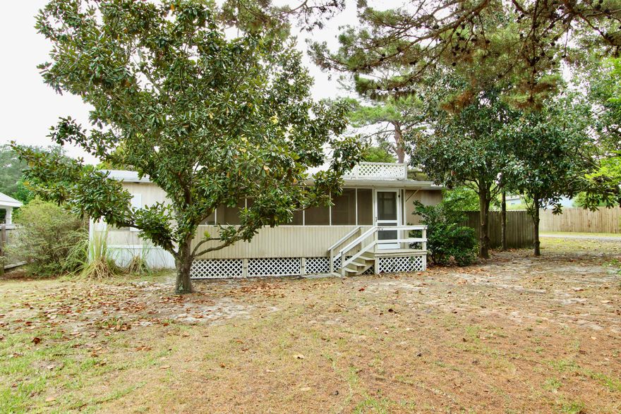 This home features 3 bedrooms and 2 full baths. It is a split floor plan and the kitchen has an eat in bar, formal dining room. There is plenty of trees to provide shade around the property. The home has 2 covered porches and a detached 2 car carport. It is close to the beaches, shopping, and restaurants. The HVAC is new. Schedule your tour today!