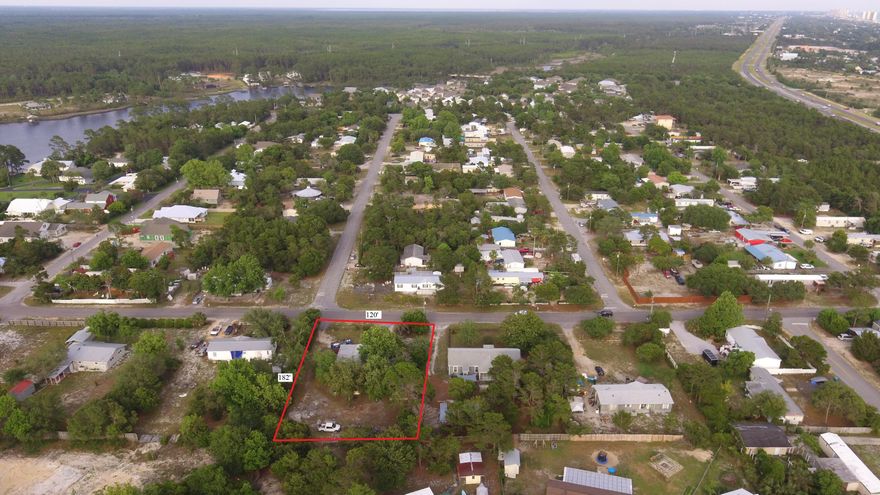 Large half acre lot on the west end of Panama City Beach with no HOA.  Live close to grocery stores, restaurants, shopping, public boat launch and the beach. No value given to the mobile home demo and start over with your choice of a single family home or a duplex. Lot appears to be able to be split into 2 1/4 acre lots which would allow for 2 homes or 2 duplexes. Position your home or multifamily investment just 2 miles from 30A and Rosemary Beach, 7 miles to Pier Park and 1 mile to Lake Powell. Buyer to verify important information.