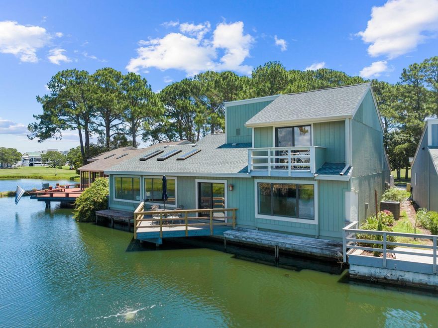 Discover the unparalleled charm of Linkside at Sandestin Golf & Beach Resort, a waterfront sanctuary offering unobstructed views of the lagoon, golf course and Choctawhatchee Bay. This exceptionally large vacation home is one of only two such properties in the coveted Linkside community, providing a unique blend of luxury and tranquility. Step inside to find a spacious open floor plan with four bedrooms and three bathrooms. The fully-equipped kitchen seamlessly connects to both the dining area and breakfast nook, making it perfect for entertaining. Enjoy your meals at the dining table that seats six or the cozy breakfast table for four, all while taking in the picturesque views through expansive windows. The high-ceiling living room boasts expansive wall-to-wall picture windows, triple skylights and is designed for relaxation, perfect for family movie nights or simply enjoying the serene surroundings. The large master suite, located upstairs, boasts a king-sized bed, private ensuite bathroom and a private balcony with stunning lake views. Also upstairs, a bedroom with two twin beds provides additional sleeping space. On the first floor, two bedrooms with queen beds offer convenient ground-floor living . Outside, unwind on your private deck overlooking the tranquil pond and watch the graceful herons wade by. Additional features include a new roof, new HVAC and a new water heater, ensuring modern comfort. The property also offers two carports and a separate self-contained air-conditioned and heated area with sliding French doors that could serve as an office or flex space. Located in the quiet and relaxing Linkside community on the bay side of Sandestin, this home exudes a true neighborhood feel. Enjoy access to the Sandestin Owners Club with multiple pools, including a heated pool near Baytowne. Explore the area on foot, by bike or golf cart. A tunnel under U.S. 98 provides direct access to the beach, enhancing the coastal living experience. With its extraordinary views, generous living space, and prime location near shops, restaurants and Baytowne Wharf, Linkside is perfect as a full-time residence, second home or rental property. This light-filled one-of-a-kind home in Linkside offers a rare opportunity to experience the best of Sandestin living.