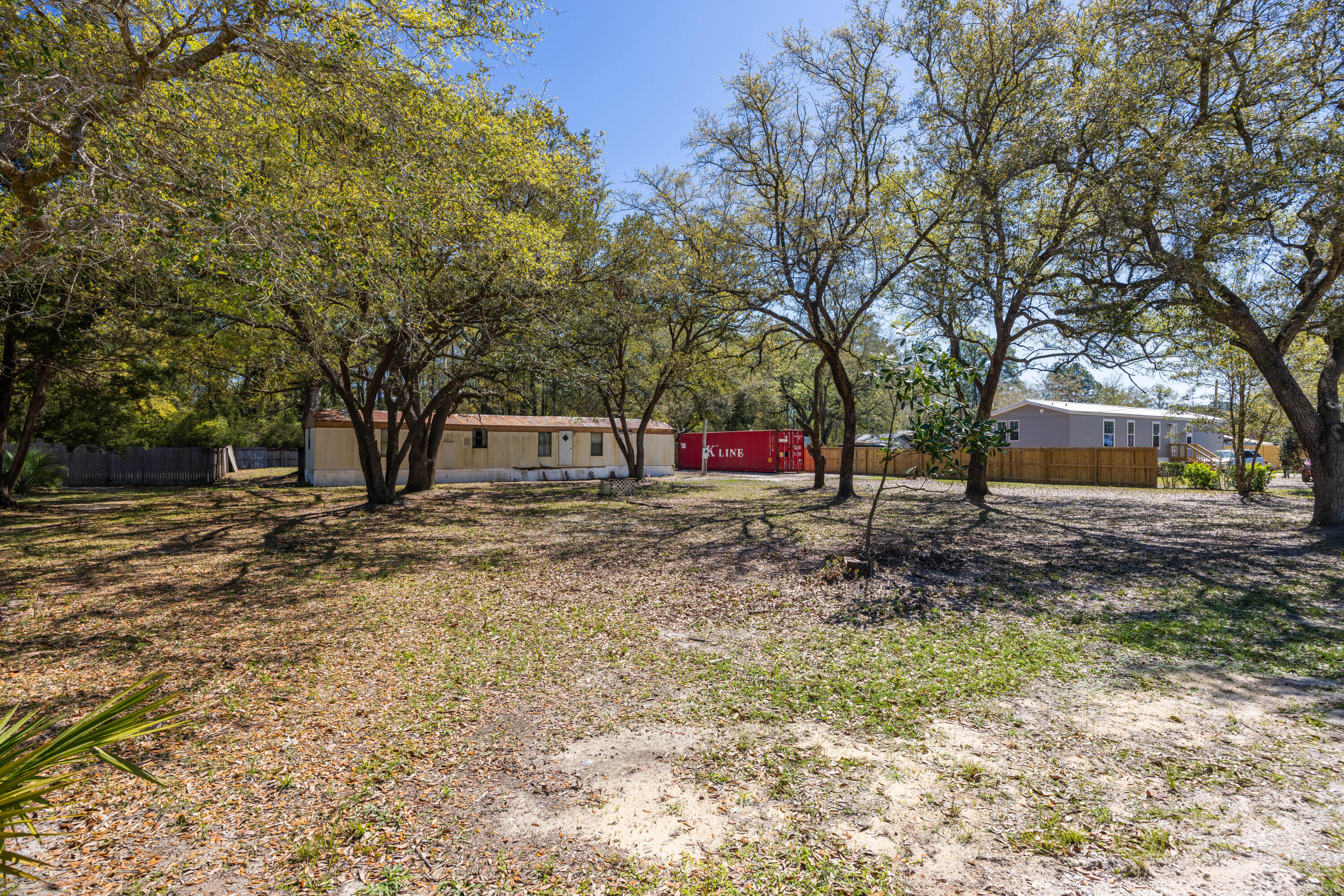 Opportunity awaits at this prime parcel nestled in an area of NO HOA or RESTRICTIONS!!! Imagine your dream home amidst a mature canopy of huge live oaks providing natural beauty on .56 acres. The perfect blend of tranquility and convenience situated towards the end of a peaceful, privately maintained street that boasts very little traffic. Create your very own container home with this Certified Cargo Worthy, shipping container that already exists on the lot, or use as a great storage!) This property is partially fenced with a sizeable shed in good shape for additional storage. Zoned Rural Village, allows for auxiliary dwellings. NO FLOOD insurance required and No Wetlands per GIS mapping. Conveniently located between Destin and Panama City Beach. Easy access to Hwy 3280 and Hwy 331 bridge with NO TOLLS. Spend your weekends enjoying the endless array of outdoor activities and water sports, some including (fresh or salt water) fishing and convenient parks for hiking and exploring. Plenty of space for all your fun recreational toys! Multiple public boat ramps nearby!
Only six minutes to Publix grocery store and approximately 15-20 minutes from some of the most beautiful white sandy beaches on Florida's Emerald Gulf Coast. Take advantage of the close proximity to fabulous shopping and restaurants on 30A, and the World famous Crab Island.
Within the up-and-coming progress of Walton County, the City of Freeport has approved and funded plans for the expansion of city sewer to this area within the next year. Secured by a 6.5 million dollar grant, Dewberry Structural Engineers will notify of future meetings to come.
Existing improvements include septic and power pole. City water is available.
This parcel offers a lot of freedoms to make it your own!! Older mobile home (considered of no value) may allow flexibility from the county for you to utilize an RV while making improvements to the property and/or building a new dwelling.
Call today for an appointment to preview the property!
All Information and dimensions to be verified by the buyer. Buyer is responsible to verity with county and/or local resources to ensure they can do what they want to with the property.