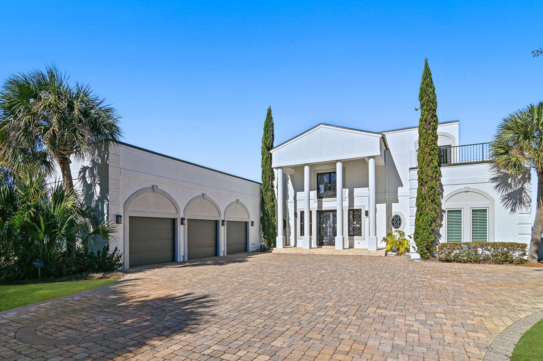 In the prestigious Emerald Bay community, this bayfront home epitomizes elegance and luxury. Positioned on a private cul-de-sac street, the property offers breathtaking views of the bay, accessible via a private pier leading to a hydraulic lift boat dock. The home's grandeur is immediately apparent upon entry, with a dramatic circular staircase and an enormous living area that seamlessly flows into the dining room, overlooking the large swimming pool. This residence boasts two living areas, with the second floor versatile enough to serve as a fifth bedroom, thanks to its closet space. Each bedroom offers stunning bay views and opens onto expansive balconies, perfect for entertaining or private enjoyment. The master bath is a highlight, featuring a corner whirlpool tub and extra-large walk
