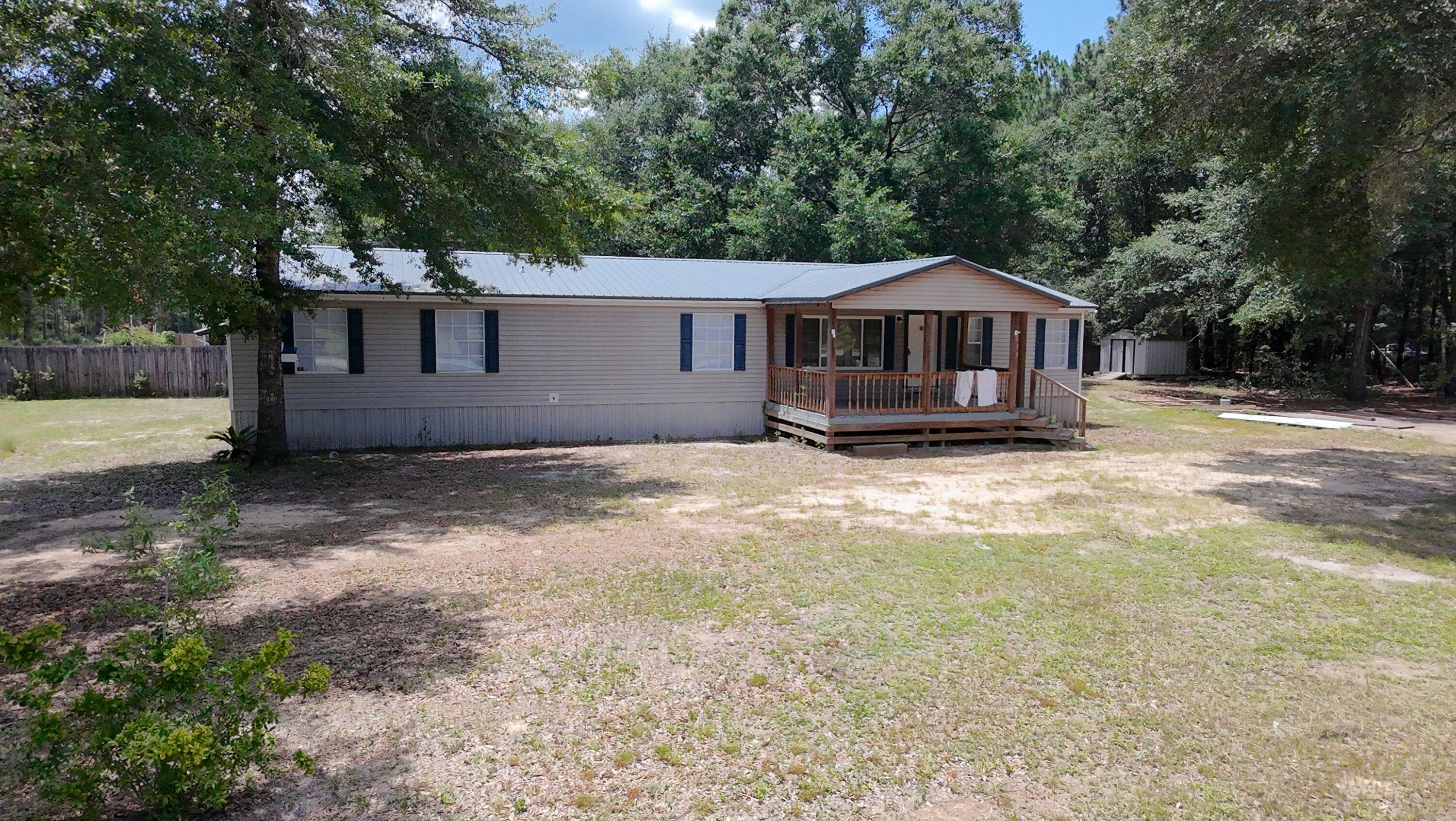 Looking for a home for a large family in a quiet neighborhood. This 4 bedroom 3 full bath plus extra office/bedroom manufactured home has been recently updated with new, paint, new LVP floors, water heater, A/C unit. and much more. This home also offers a living room with a large den with fireplace that is open to the living room/dining area. Kitchen has an island and tons of cabinets! Large master bed and bath rooms and walk in closet New metal roof about 3 years ago. Paved road, Over half an acre corner lot, concrete parking area, yard building, close to schools, shopping, and several parks and lakes. Less than an hour to the beach.